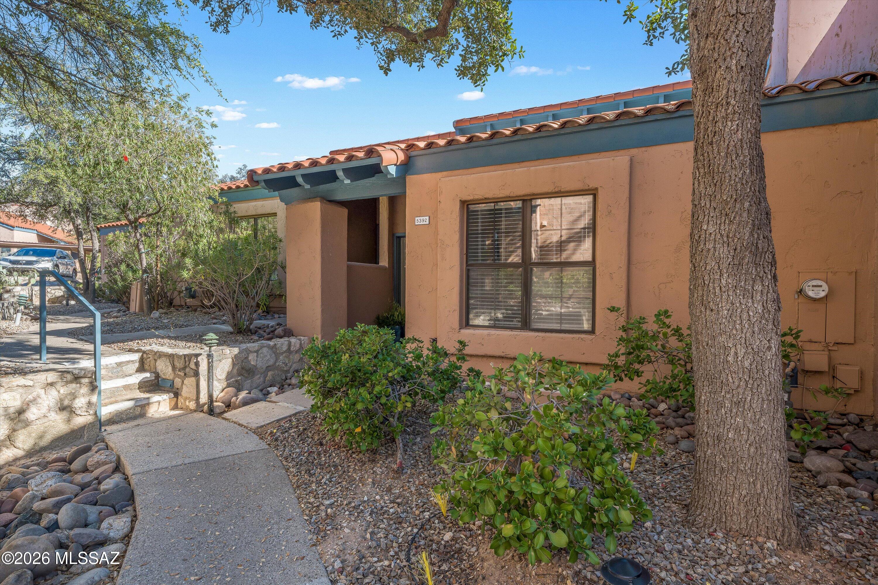 Unique home near Sabino Canyon featuring a dramatic two-story wood cathedral ceiling that fills the living area with natural light. Recent upgrades include: new stainless steel oven/range and dishwasher, new wood-laminate flooring in the living areas and bedroom, and an updated bathroom with new tub, tile, flooring, and fixtures. Fresh white interior paint and new window coverings create a clean, modern feel. A skylight brightens the bathroom, and the large covered patio opens to peaceful open space behind the home with lots of privacy. Charming tree-lined path leads to the entrance, highlighted by a 30-foot live oak providing summer shade. Located less than a mile from Sabino Canyon Recreation Area. Heated community pool. No one above or below. Listing agent is related to sellers.