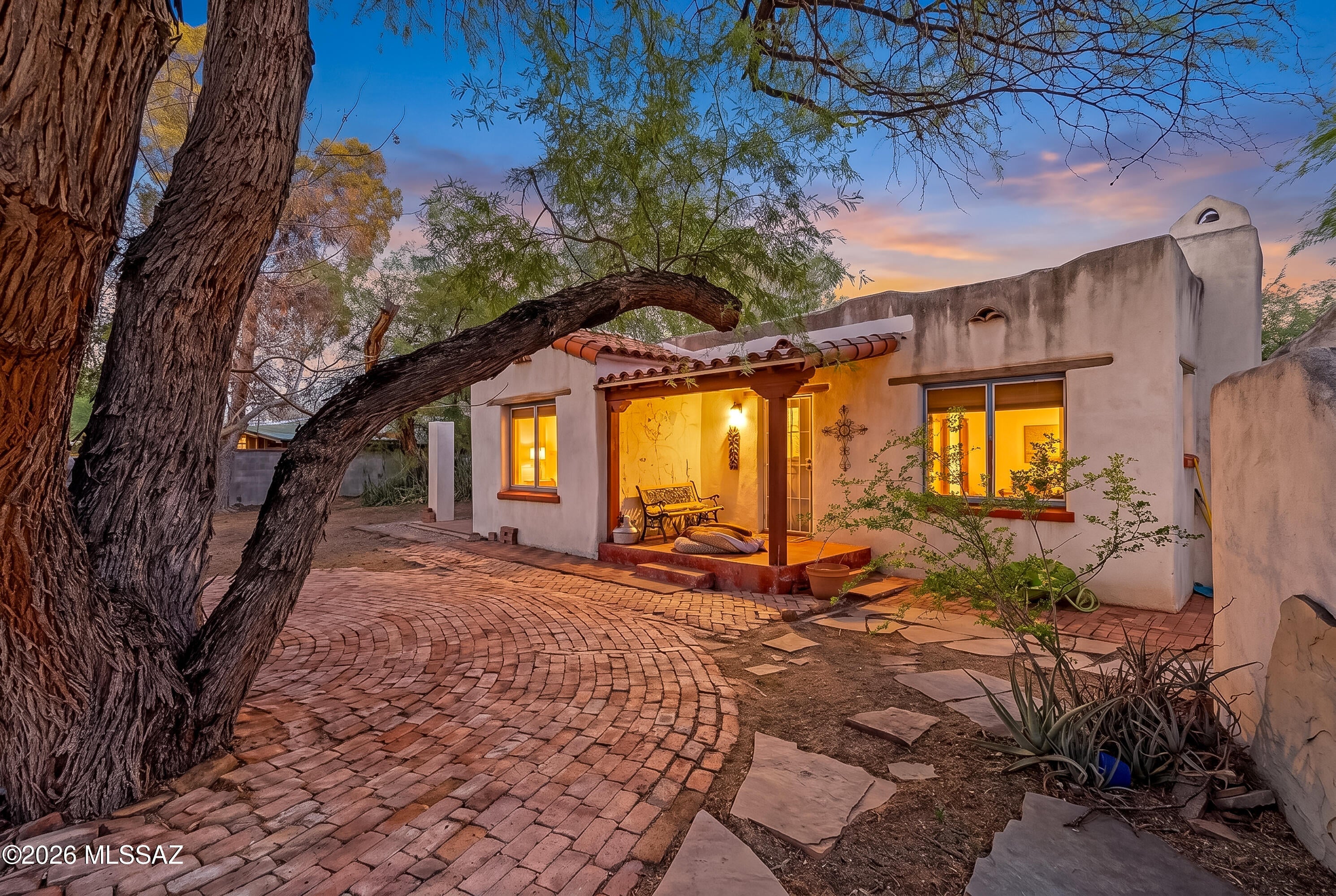 Rare opportunity to restore a truly distinctive old-Tucson adobe compound on a generous double lot in historic Speedway Park. Three separate adobe structures including a 3BR main residence, 1BR guest house w/kitchen & artist studio/workshop all connected by courtyards & cute patio areas! Handcrafted details evoke Tucson's Sonoran Desert heritage & Old Mexico style including substantial adobe walls, coved ceilings brick & original wood floors, stained glass & wood, wrought-iron & tile accents throughout. Huge lot w/shaded areas & plenty of room for pool or gardens allow for anything you can dream of. A unique property w/historic charm, creative possibilities & a rare amount of land-this one Is ready for significant restoration & investment opportunities! See supplemental remarks... The property has an unmistakable old-Tucson character, with handcrafted details and influences inspired by traditional Sonoran Desert adobe homes and old Mexico. Throughout the compound are hand-painted tile, Saltillo and terracotta flooring, stained glass, carved wood, wrought-iron accents, adobe niches, mosaics, terracotta vessels and other unique details that give the property a collected, artistic feel.

The main adobe residence is centered around a large living room with substantial hand-finished adobe walls, coved ceilings, wood floors and a traditional fireplace. Three bedrooms branch from the central living space. The separate one-bedroom guest house includes a kitchen, living area and bath and provides a more conventional independent living space. A third adobe structure serves as an artist studio/workshop.

The generous double lot allows the buildings to be arranged more like a private adobe compound than a typical residential property, with courtyards, shaded portals, ramadas, patios and gravel pathways connecting the spaces. A central courtyard features a mature mesquite, niches and an area for a fountain, while other areas offer opportunities for gardens, outdoor gathering spaces and creative use.

This is a highly individual property with architectural character, history and potential that would be difficult to replicate today. The property is a substantial fixer and will require significant work and investment, offering an opportunity for the next owner to restore and reimagine this unusual Tucson compound.