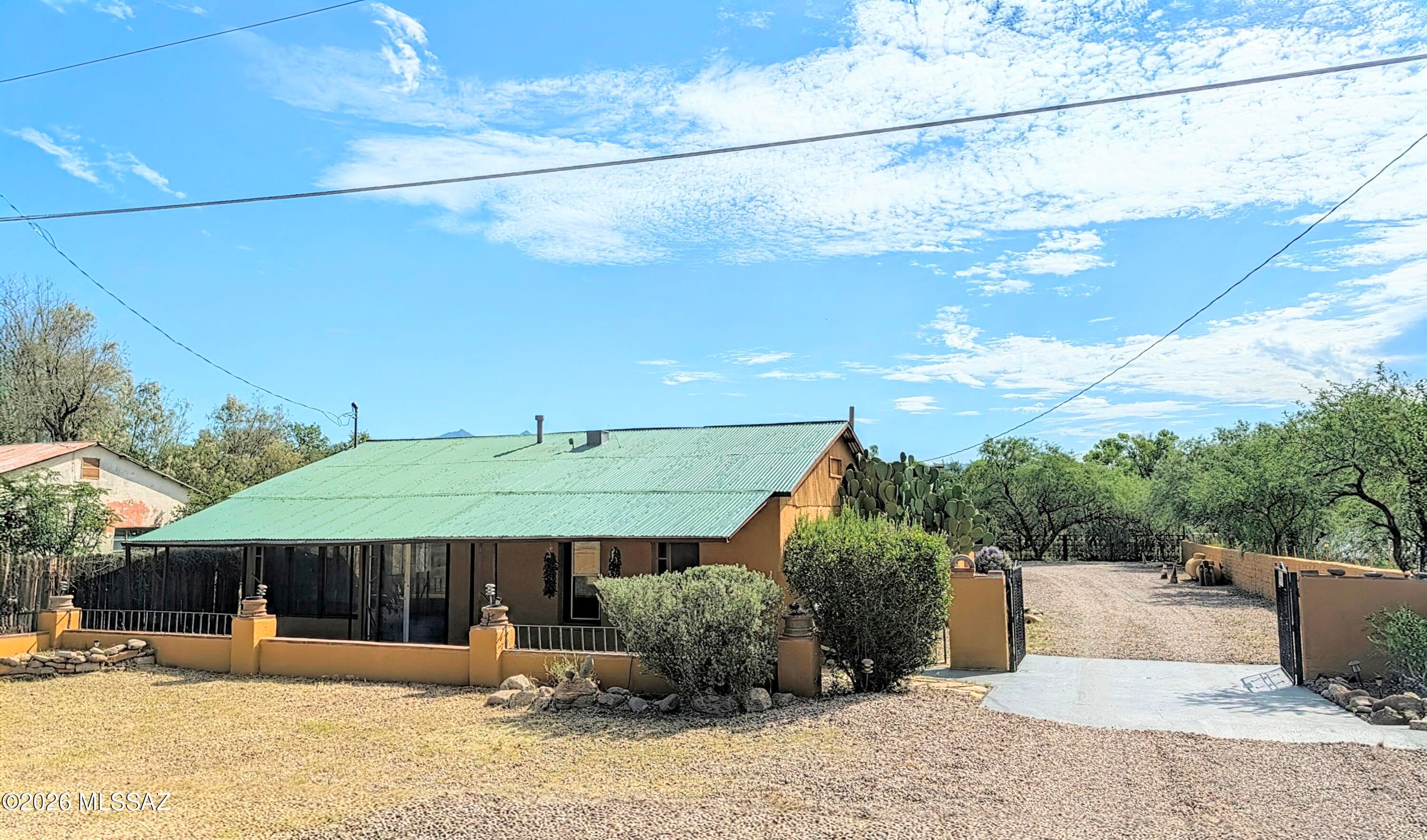 Unlock the ultimate investor dream with this fully restored, versatile multi-use property offering endless potential. Perfectly blending historic charm with modern updates, this rare find features a distinct commercial gallery/studio up front and a comfortable residential home in the back--all set against stunning mountain views and gorgeous sunsets, just under 5 minutes from downtown Tubac. Dual-Income or Live-Work Setup: Includes a 1120 sq ft commercial gallery/studio up front and an 1183 sq ft residential home in the back, each with its own separate utility meters. Classic adobe construction beautifully preserved and enhanced with a fresh coat of paint. Features a brand-new private well, a new septic tank, updated roofs, freshly painted concrete floors, and new carpet in the home. Includes two owned propane tanks powering the gas stoves and furnace.
Ample Parking & Storage: Includes a 2-car detached garage, 2 storage sheds, an oversized carport, and generous parking space for customers or personal use. It's a fully fenced and gated property, with RV parking space.
There are charming front porches on both the gallery and the main house, to take in the serene desert surroundings.
Endless Business Potential!!!
The front gallery space has a rich history of versatility--previously serving as an art studio, paint shop, sign shop, and retail storefront. Whether you envision launching your own boutique business, opening a creative studio, or securing a high-potential investment property, this turnkey estate brings your dreams to reality.