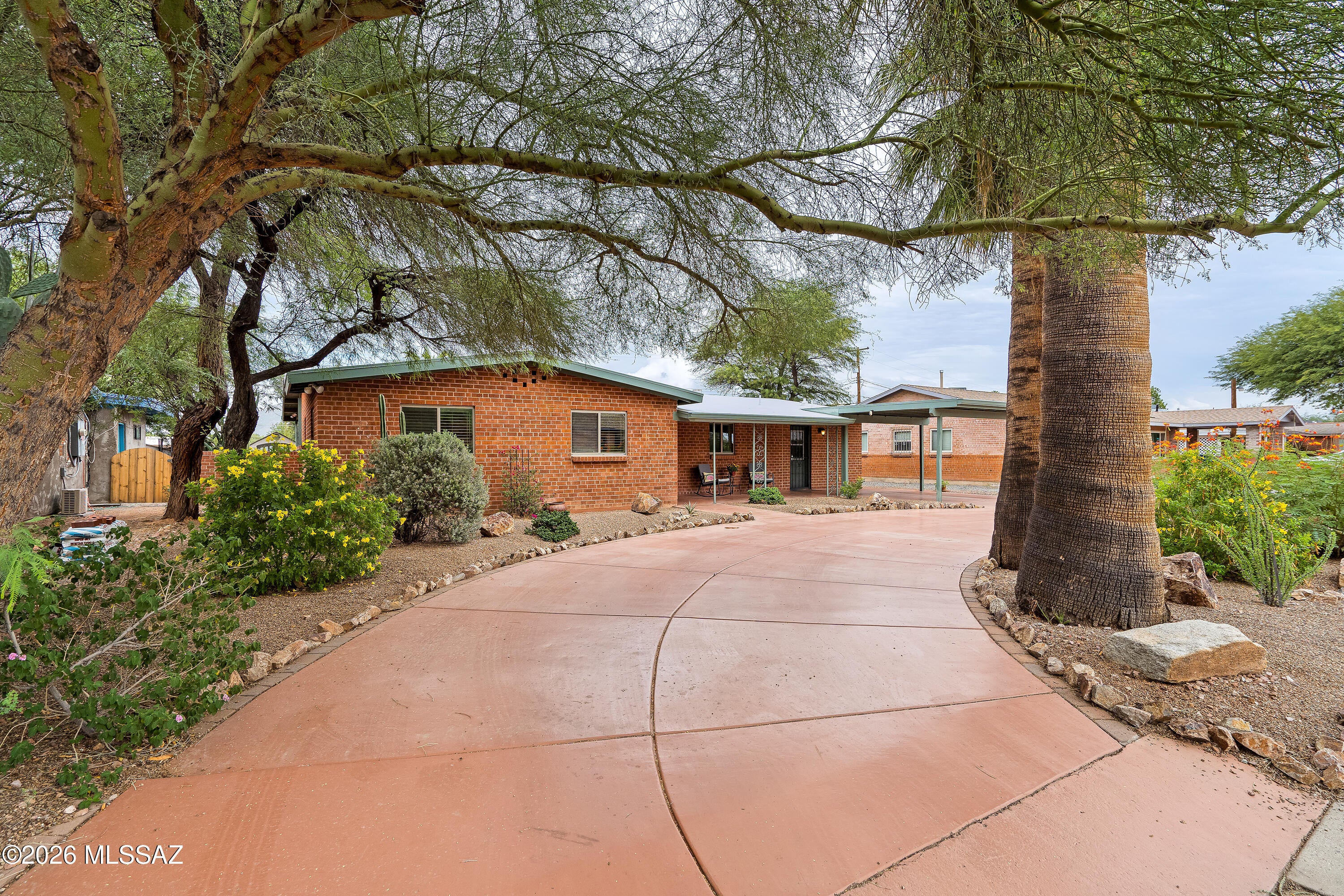 Immaculate, updated and thoughtfully maintained, this inviting ranch home offers the perfect blend of character & modern comfort in a highly desirable central Tucson location. Open kitchen featuring stainless steel appliances and layout designed for easy living. High ceilings, family room with fireplace, updated bathrooms, generous living spaces, and the convenience of having all appliances convey make this home move-in ready. Low maintenance, park-like backyard with mountain views, artificial turf, pavers, covered patio, mature landscaping. Additional highlights include a circular driveway, covered parking, inviting front yard space. Just a short distance from the neighborhood park and the Campbell corridor featuring numerous coffee shops, restaurants, and shopping. Floor plan available.