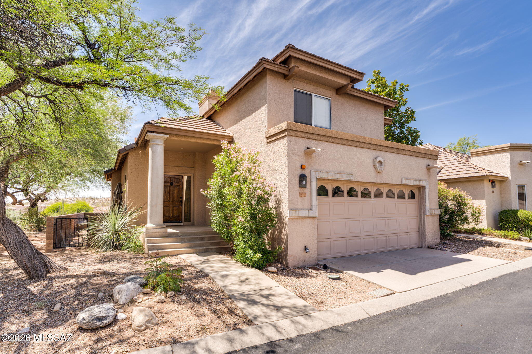 Charming Southwestern-style home in the highly sought-after, guard-gated Las Palomitas community. 3 bed, 2.5 bath two-story with tile flooring downstairs and hardwood upstairs. Bright, open kitchen with alder cabinets, granite countertops & stainless steel appliances. Inviting living room with wood-burning fireplace. Beautiful backyard with mountain views. Minutes to La Encantada for premier shopping, dining, golf & hiking. Located in top-rated Catalina Foothills District 16. HOA covers front yard maintenance, trash & community pool. Offered fully furnished for seamless move-in experience. Recently painted exterior . New HVAC and heater