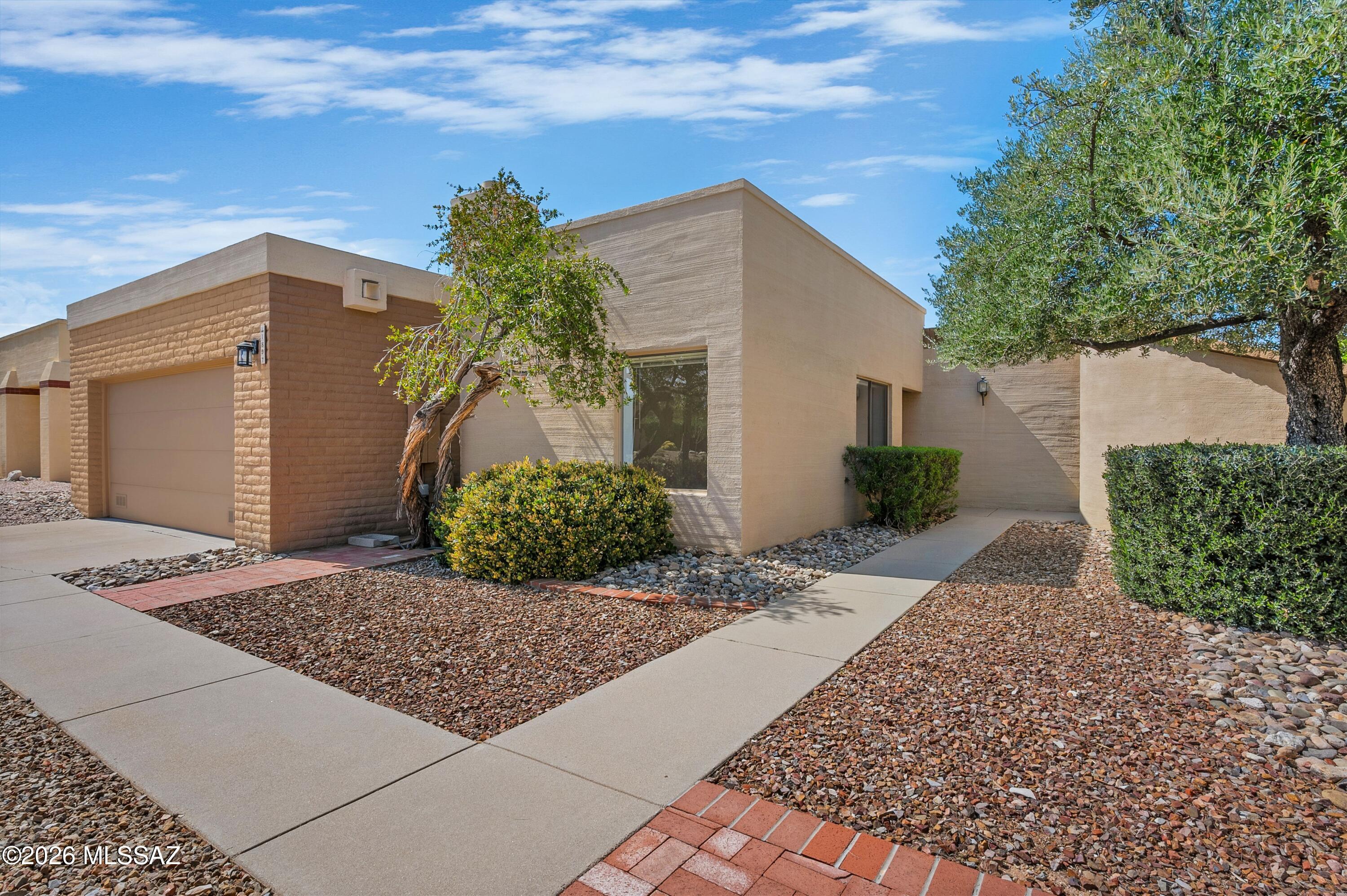 This inviting home features a welcoming living room with a traditional beehive fireplace (gas). Bedroom 3 has a sliding glass door that opens to the atrium, creating a bright and versatile space--perfect for an art studio, hobby room, or home office. The washer, dryer, and refrigerator are all included, along with a newer HVAC system. Perfect  for lock-and-leave residence. Fountain Park amenities include a community pool, play area, and scenic walking trails. Enjoy move-in-ready, low-maintenance living. Make it yours today.