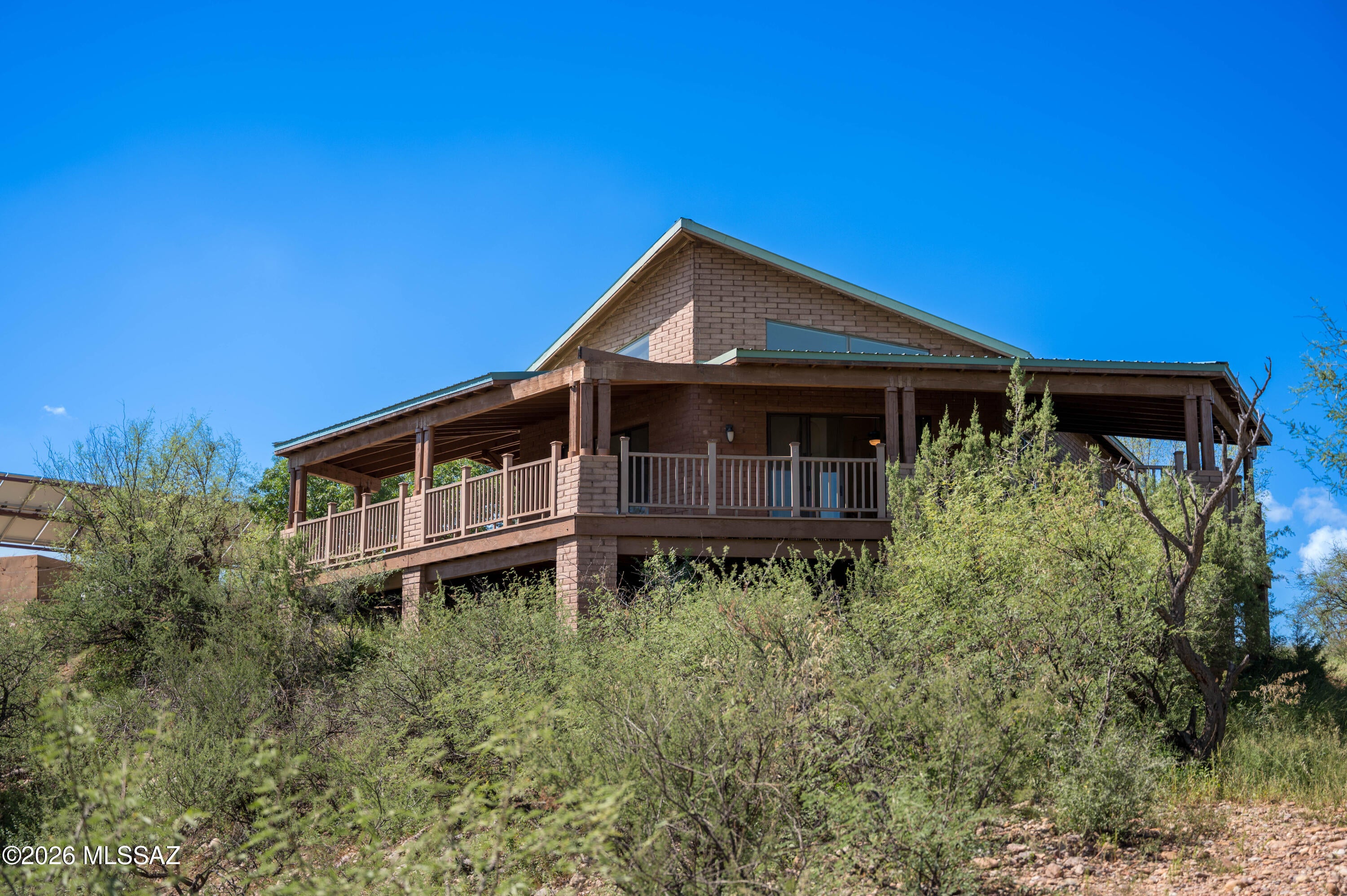 Experience privacy, space, and breathtaking scenery on this unique 38-acre ranch located next to Sonoita Creek. Surrounded by beautiful mountain views and natural desert landscape, this property offers a peaceful retreat with plenty of room to enjoy the outdoors. The home features 2 bedrooms and 1 bathroom, a private water well, and a balcony showcasing expansive mountain views. Relax or entertain outdoors under the gazebo, gather around the fire pit, and enjoy the serenity and open space this remarkable property has to offer. A special opportunity for those looking for privacy, acreage, and the beauty of Southern Arizona.
