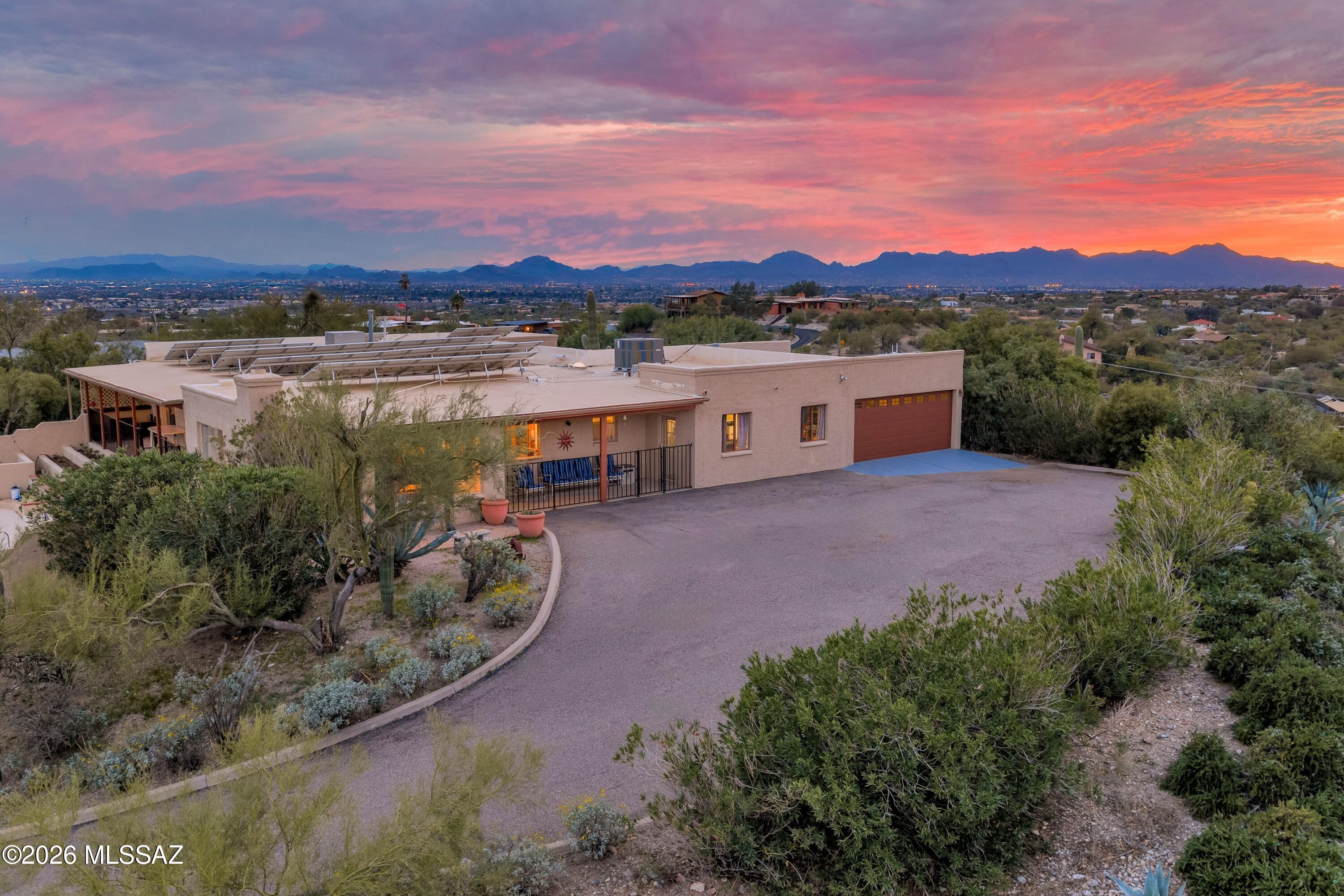 This beautiful Catalina Foothills 5 bedroom, 3 bath  incredibly versatile floorplan is situated on an elevated .9 acre lot with the most magnificent views of the Catalinas, Rincons, Santa Ritas AND the Tucson Mountains NOT to mention the City Lights. So much has been done here to include a newer roof, HVAC systems, plus recently resurfaced pool/spa! The kitchen is remodeled with smart flow & great work spaces plus a view of the mountains to inspire! The current LARGE office could be a MIL suite or Rec Room with ease. The family room has a fireplace & yet more views. The living & dining rooms open to the east facing patio with glorious sunrises. The heated pool & spa have been recently resurfaced. Dual cooling. Oversized garage for added storage. Owned solar means utilities are minimal.