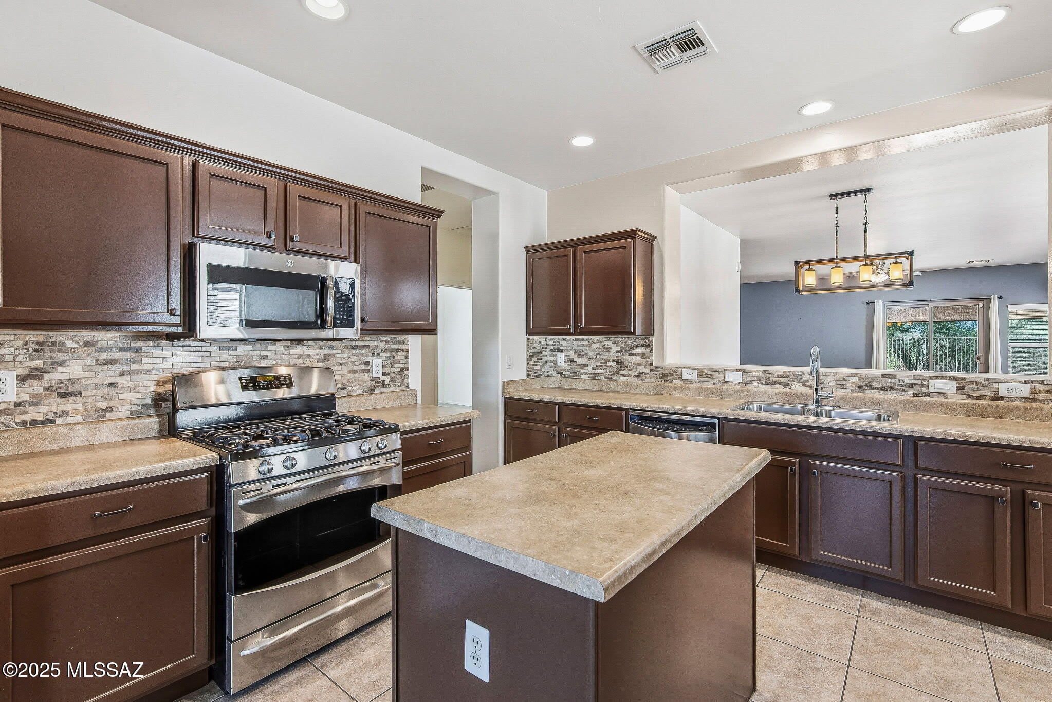 Move-in ready 4 bed, 2 bath home in beautiful Rancho Sahuarita! This spacious 1,800 sq. ft. home features a chef's kitchen with an island, freshly painted cabinets, and a bright breakfast nook, plus a separate formal dining area perfect for entertaining. The large living room offers plenty of space for gatherings, and the AC is only about 3 years old. Step outside to a low-care backyard with a cozy seating area around the fire-pit, ideal for enjoying Arizona nights. Enjoy all the incredible amenities Rancho Sahuarita has to offer, including scenic trails, pools, playgrounds, a fitness center, and year-round community events!
