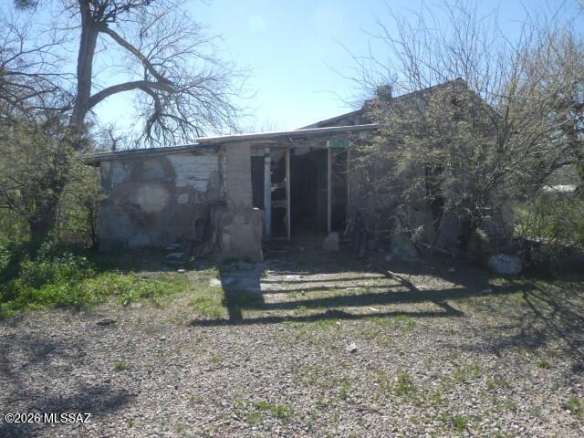 Major fixup, large lot, has pool well, septic, fence, entrance via 60' access on east side of 86810 E Vieros St.  Stone and stucco exterior walls , wall has hole for wood stove.  Large metal bldg could be used for animals.  Has well (well no. 649742 80' deep), pool.