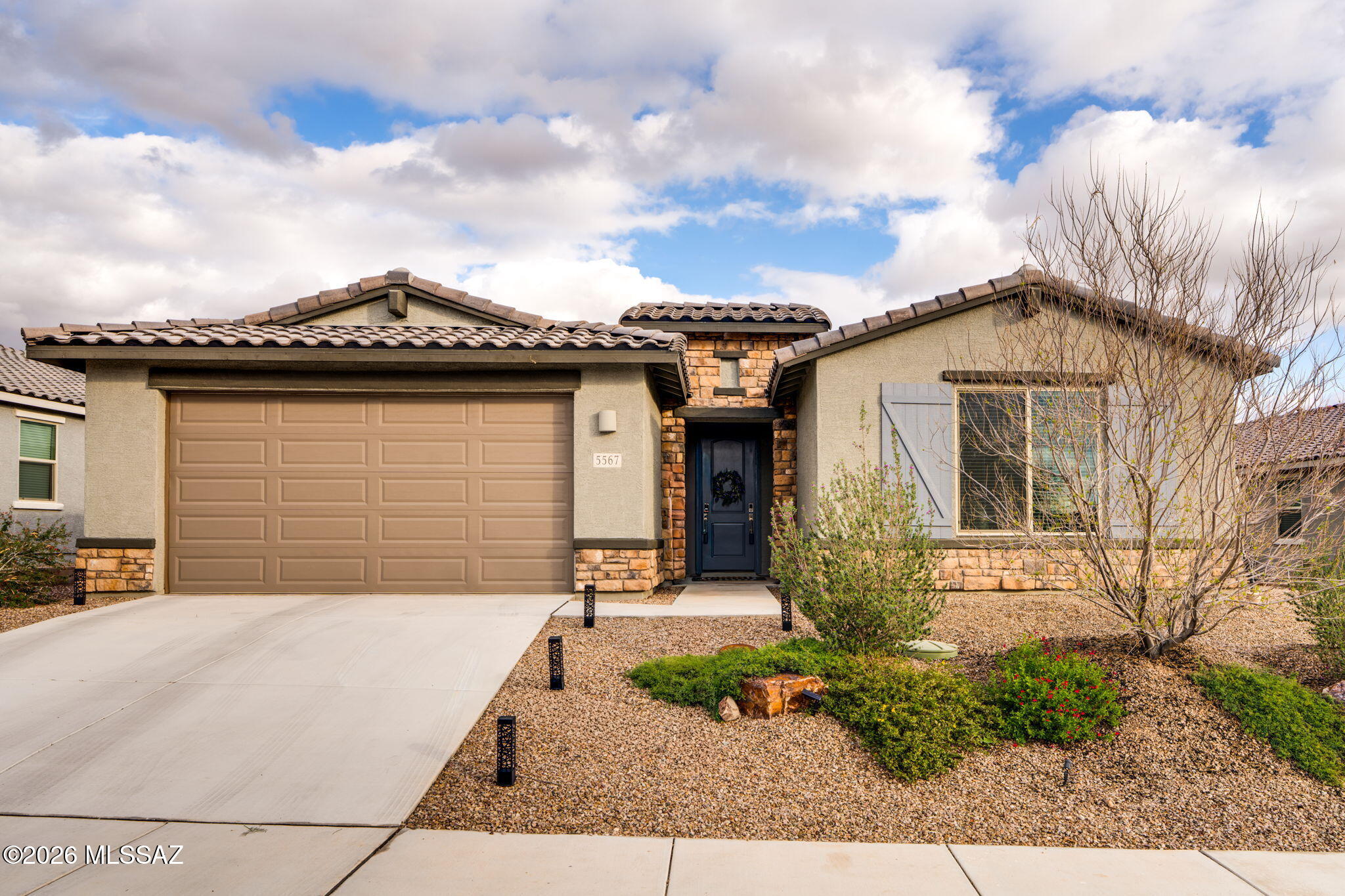 Located in a highly desirable NW gated community with quick access to I-10, this like-new home offers tasteful finishes and thoughtful upgrades throughout. The open-concept floorplan features a spacious great room flowing into a gourmet kitchen with gas cooktop, vent hood, stainless steel appliances, and granite counters. A split-bedroom layout provides privacy, with the primary suite offering a spa-like shower, generous space, and a walk-in closet. Enjoy a large laundry room, two oversized closets for extra conditioned storage, and numerous custom touches. The low-care backyard features turf, additional paver Ramada seating, and mountain views. Complete with a 3-car tandem garage.