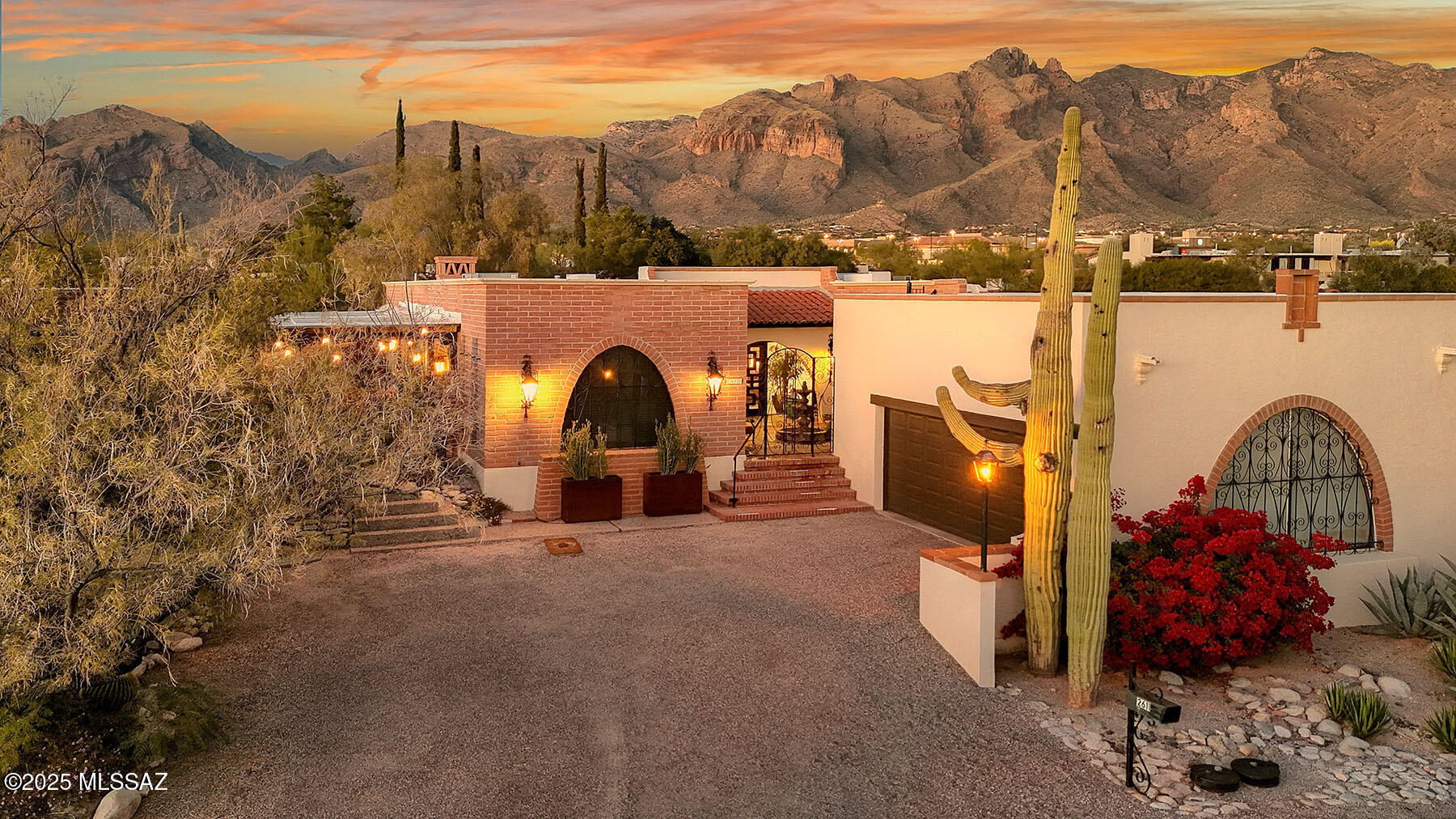 This tastefully updated, classic Tucson burnt-adobe territorial townhome is located in the highly sought-after Catalina Pueblo community in the heart of the Catalina Foothills. The residence is privately situated on a quiet cul-de-sac away from traffic noise, yet close to La Encantada Mall, restaurants, art galleries, and shopping.  Rich with Spanish and Mexican design accents, this charming and well-flowing 2,513 sq. ft. home offers three bedrooms plus a living room with dining area, and a family room.  Enter the residence through a welcoming courtyard with a fountain, a circular staircase ascending to an observation deck with sweeping city and mountain views, and an inviting front porch beneath a chinked mission-tile roof leading to a designer iron front door — capturing the true character and charm of Tucson living.  The oversized 19' x 30' living room features engineered wood-grain flooring, a grand chandelier in the dining area, and access to the north facing covered patio  providing exceptional space for entertaining.  The comfortable family room offers a wood-burning fireplace, exposed adobe walls, and a high beamed ceiling with hand-crafted corbels.  Light and bright, the remodeled kitchen offers slate countertops, stainless steel appliances, a farmhouse sink, a walk-in pantry/laundry room, and a breakfast area that opens seamlessly to the covered west-facing patio. The office/third bedroom showcases exposed burnt-adobe walls, an en-suite bathroom, and built-in cabinetry. The primary suite features a remodeled designer bathroom with dual sinks and a walk-in closet.  The oversized 2-car garage provides abundant storage options. Additional guest parking and access to three community pools further enhance this exceptional offering! Property may not be purchased as a rental. A rare opportunity, must be seen to be appreciated!