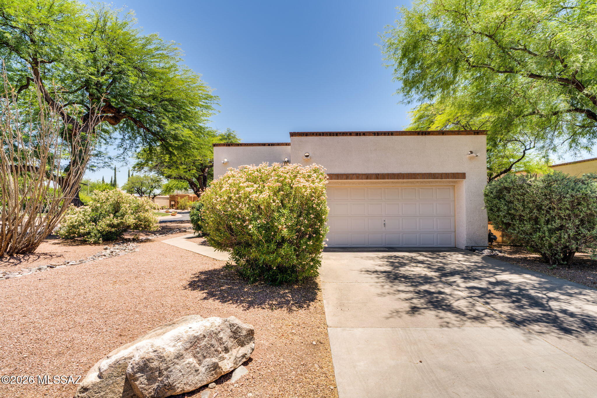 Nestled within the gated enclave of San Miguel, this Corner Lot, 2-bedroom, 2-bathroom residence offers an unparalleled blend of privacy and convenience. Moving seamlessly through the flexible floorplan, you will find absolutely no carpet, only cool, high-end stone flooring. The formal dining area opens to a beautifully shaded private patio perfect for al fresco evenings. San Miguel itself is renowned for its manicured grounds and peaceful atmosphere. This particular residence enjoys a premier location within the neighborhood, being situated just steps from the community center. Cool off in the serene neighborhood pool or host events in the beautifully appointed community gathering area. Beyond the privacy of your secure gates lies effortless access to the very best of Tucson's lifestyle You are just a short drive from the Loop trail parking for cycling and walking, as well as the historic Old Ft. Lowell district, which features a sprawling park and a highly anticipated, soon-to-be-built museum and extended park grounds. Whole Foods is just minutes away, while the vibrant local scene at nearby Plaza Palomino beckons. Whether you are indulging in brunch at the beloved local staple Le Buzz, catching the game with friends at Trident, or spending an afternoon exploring curated, locally owned boutiques, everything you need is at your fingertips.