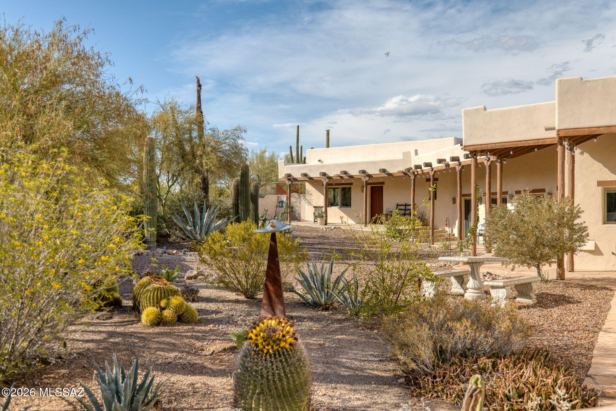 The rush of the city fades to a palpable silence as you wind your way into the foothills of the Tucson Mountains to the Horseback House, where the romance of the Sonoran Desert becomes a part of your daily rhythms. Access to the network of trails that meander their way through nearby Sweetwater Preserve is within walking distance, providing ample opportunity for spontaneous hikes. Inside the home you'll find Southwestern-inspired living at its finest. Warm saltillo tile throughout creates an organic aesthetic and successfully establishes a true sense of the Southwest within the home, further enhanced by the rustic viga beams that span the length of the main living space. Five sets of French doors in both the living space and dining room bathe the interior of the home in natural light while granting views of both the urban sprawl of Tucson below and the soaring peaks of the Tucson Mountains above. The kitchen is an exercise in the skillful balance of both functionality and style, having been fully reimagined under the care of an award winning interior designer. Quartzite countertops crown custom cabinetry while an Ilve range sits beneath a bespoke range hood, and a paneled SubZero refrigerator provides unparalleled performance where it matters most. 
Since 2023 this home has seen its share of upgrades, ensuring smooth operation of systems behind the scenes: the kitchen has been outfitted with a new appliance package (with the exception of the existing SubZero refrigerator), new tankless water heaters furnish hot water on demand, upgraded electrical panels offer enhanced capabilities for your power needs, while new air conditioners provide zoned cooling and maximize energy efficiency. 
A desirable composition of both native desert landscaping and mature fruit trees clothe this over three-acre horse property, creating a balanced + grounded feel in the outdoor living spaces. An extensive ramada and glassy saltwater pool provide year-round outdoor enjoyment just outside your back door, and the lower yard is complete with several raised beds for the gardening enthusiast.
The serenity and solitude to be found at the Horseback House doesn't come at the cost of convenience, you'll find that the University of Arizona is a 30-minute drive away, downtown Tucson 25 minutes, and grocery a short 15 minute trip down the road.
Come experience the lifestyle the Horseback House has to offer today.