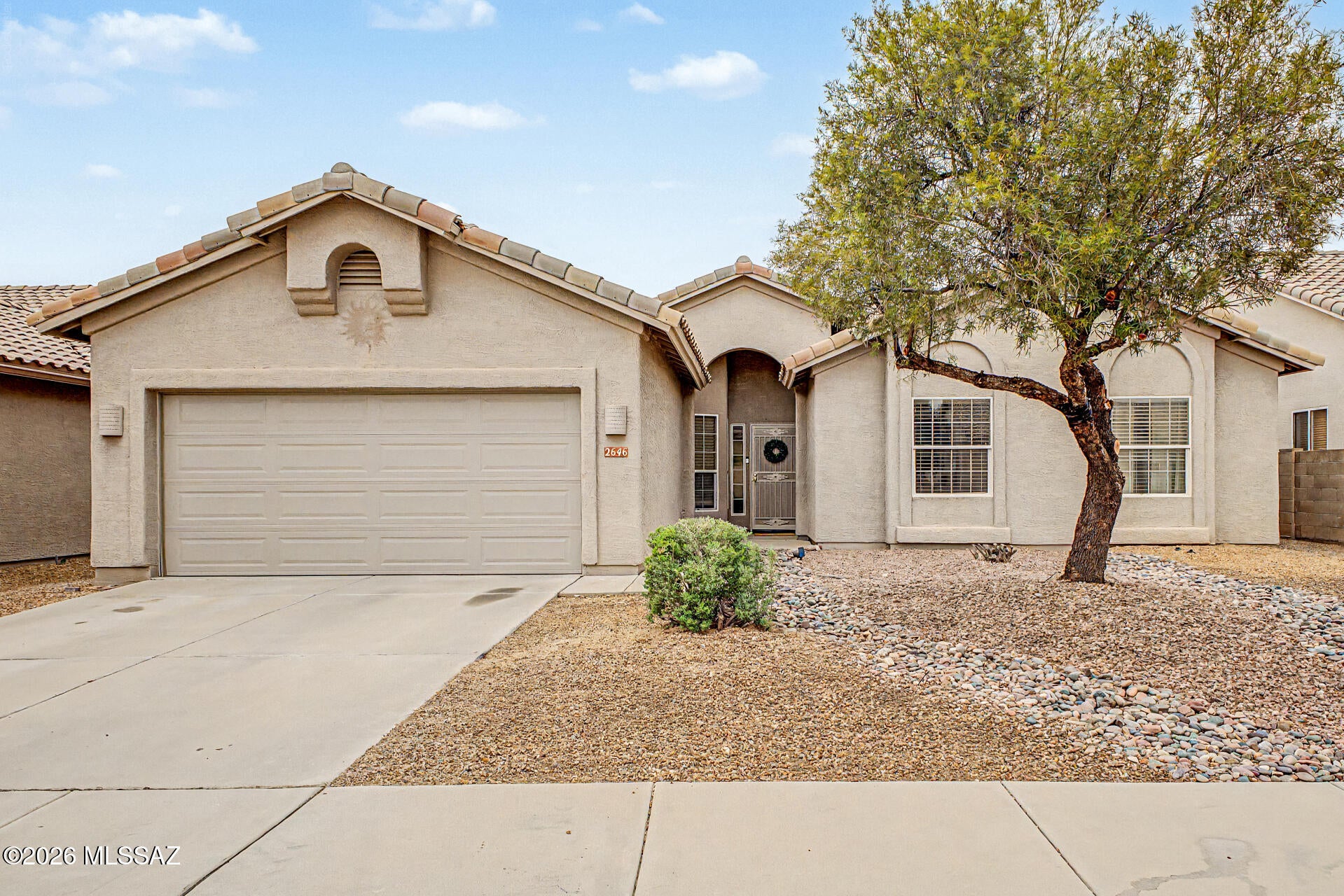The search is over! This charming single-story residence is ready to bring you joy! Inside, you'll discover thoughtfully designed living spaces featuring durable tile flooring, vaulted ceilings promoting an airy feel, arched passageways, plenty of natural light gracing every space, and a soothing palette that creates a comfortable atmosphere. The kitchen displays ample cabinetry, plenty of counter space, and built-in appliances ready for your culinary adventures. The primary suite boasts a private bathroom with dual sinks and a separate shower & tub, plus a practical walk-in closet for easy organization. Gather with family and friends in the backyard, complete with a covered patio and plenty of room for outdoor entertainment with an easy-care landscape. Don't miss this move-in-ready gem!