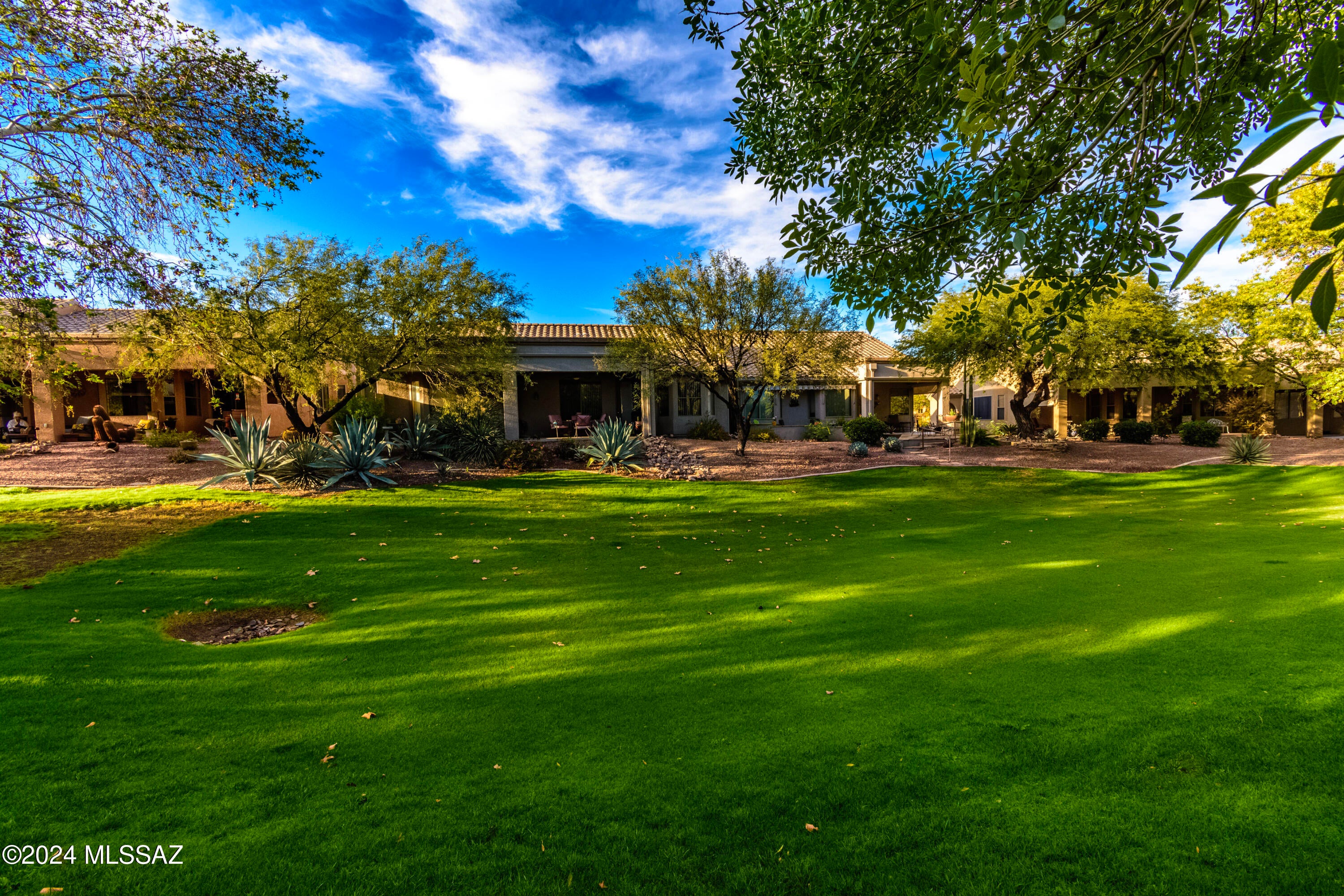Welcome to your new care-free home in Green Valley!! This home is situated at Las Campanas Village, a 55+ gated adult community where your monthly HOA covers exterior maintenance, paint, stucco, roof, front yard maintenance, irrigation, pest control, trash, hazard insurance and basic cable! This beautiful well cared for home features an open concept floor plan featuring 2 BR, 2 BA +Den. As you walk in from room to room, you will notice all the care that went into putting this home together, and making you feel welcome and at home. This well decorated home features neutral tile throughout and neutral soothing wall colors. The kitchen is perfect for entertaining with oversized cabinets a kitchen island that looks into your living room and a large pantry closet in laundry room. The owner's suite features ample size bedroom, a large walk-in shower, double vanities, walk in closet, large windows to let in natural light and Hunter Douglas blinds in bathroom and throughout home. The second bedroom is equally impressive with the second bathroom right outside the door. Den is currently used as office space and living room. The garage has a utility sink and attached cabinets for extra storage. Right outside your rear door, come enjoy your new sitting area under our magical Arizona sunsets! Perfect location to lock and go or full time living! Call me to set up your showing!