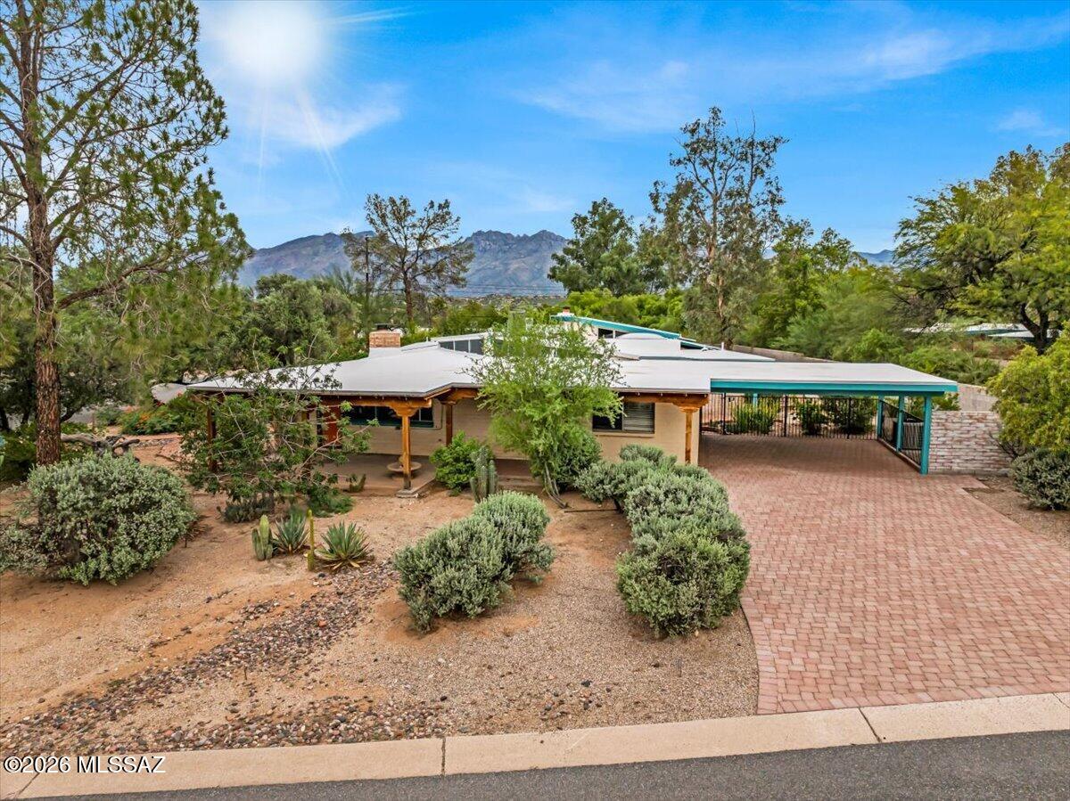 Welcome to this remarkable Mid-Century Modern residence with a private guest house, nestled in the prestigious & historic community of Indian Crest Estates, just steps from Tucson Country Club & minutes from shopping, dining, & everyday conveniences. With open desert to the north, this rare property offers an exceptional combination of privacy, character & prime location. Originally crafted by Lusk Construction in 1959, the main residence features 4 bedrooms & 3.5 bathrooms, showcasing timeless Mid-Century appeal complemented by thoughtful recent updates. The refreshed kitchen features new countertops, freshly painted cabinetry with new hardware, a new backsplash & fresh paint. Additional improvements include a new roof, new pipe liners for the wastewater lines, updated light fixtures Ceiling fans throughout, and fresh interior paint in select rooms.
Step outside to an updated backyard designed for easy-care Arizona living, complete with artificial turf, gravel, and a drip irrigation system. The separate 829 sq ft, one-bedroom, one-bath guest house offers a full kitchen and private entrance, providing an ideal setup for extended family, visiting guests, a home office, or additional flexible living space.
Set on nearly half an acre in one of Tucson's distinctive established neighborhoods, this special property blends iconic Mid-Century architecture, modern improvements, versatile living spaces, and an outstanding location.