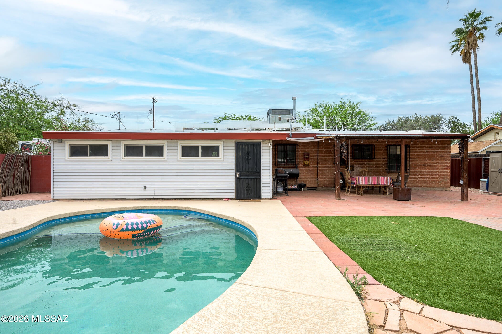 This well-maintained home reflects true pride of ownership and is located in a quiet, centrally located neighborhood. Offering 3 bedrooms and 1.5 bathrooms, the layout includes a spacious living area, separate family room, and an additional flex space that can be used as an office, playroom, or hobby room.
The home provides plenty of functional space for everyday living and entertaining. Step outside to a recently installed heated pool, creating a great setting to enjoy year-round. The property has been consistently cared for and is move-in ready, with a layout that offers flexibility to fit a variety of needs.