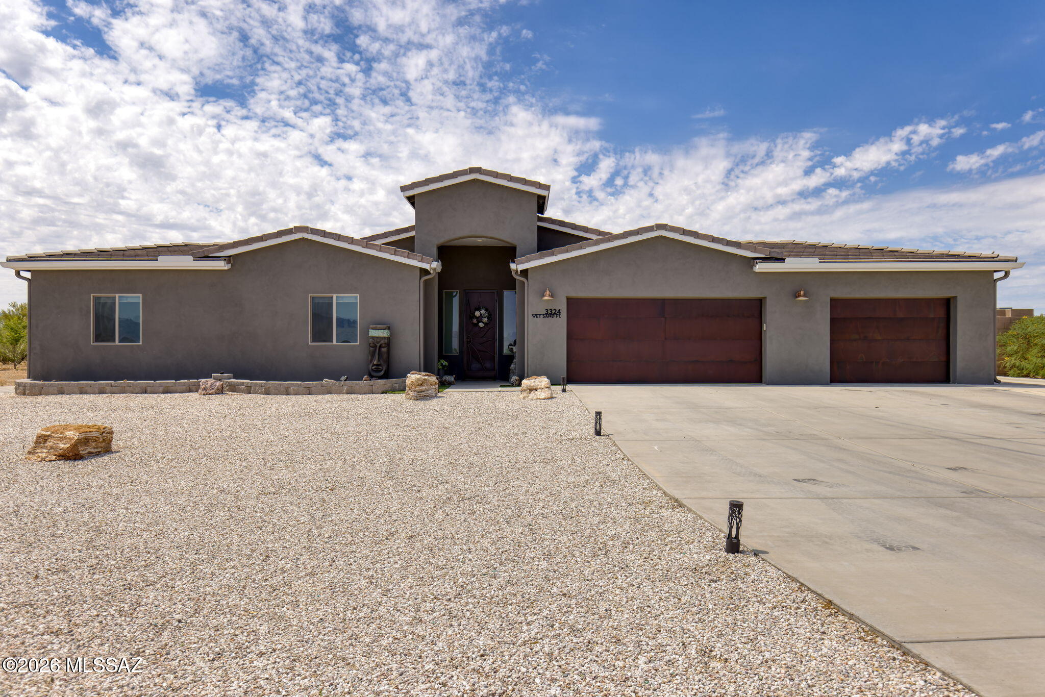 Set on a spacious cul-de-sac lot in Whetstone Shadows, this beautifully maintained 2021-built home offers wide-open surroundings, Mountain views, no HOA, and room for the RV, boat, ATVs, and additional vehicles. Inside, plank tile flooring extends throughout the home, and all four bedrooms feature walk-in closets. The open Great Room centers around a well-appointed kitchen with a large island, granite countertops, tall soft-close dovetailed cabinetry, and GE stainless appliances. The expansive backyard is designed to take full advantage of the Arizona lifestyle. Enjoy mountain views from the covered patio, gather around the fire pit on the paver patio with built-in seating, or relax beneath open skies filled with colorful sunrises, sunsets, and stars. Artificial turf, decorative gravel, and multiple outdoor seating areas create an attractive, low-maintenance setting. There is ample room to add a pool, garage, or workshop, and the property extends beyond the east block wall for even greater flexibility.
Numerous seller improvements include a water softener and reverse osmosis system, custom security doors, custom metal gates, seamless gutters, window and door treatments, an epoxy-coated three-car garage floor, an extended concrete driveway, and increased block wall height for added privacy. Diamondback Roofing also completed preventative roof maintenance in June 2026.
Located in the Vail School District and convenient to shopping, dining, and everyday services, this thoughtfully upgraded property offers modern construction, generous outdoor space, mountain views, and the freedom of no HOA. Why wait to build when this move-in-ready home is ready now?
