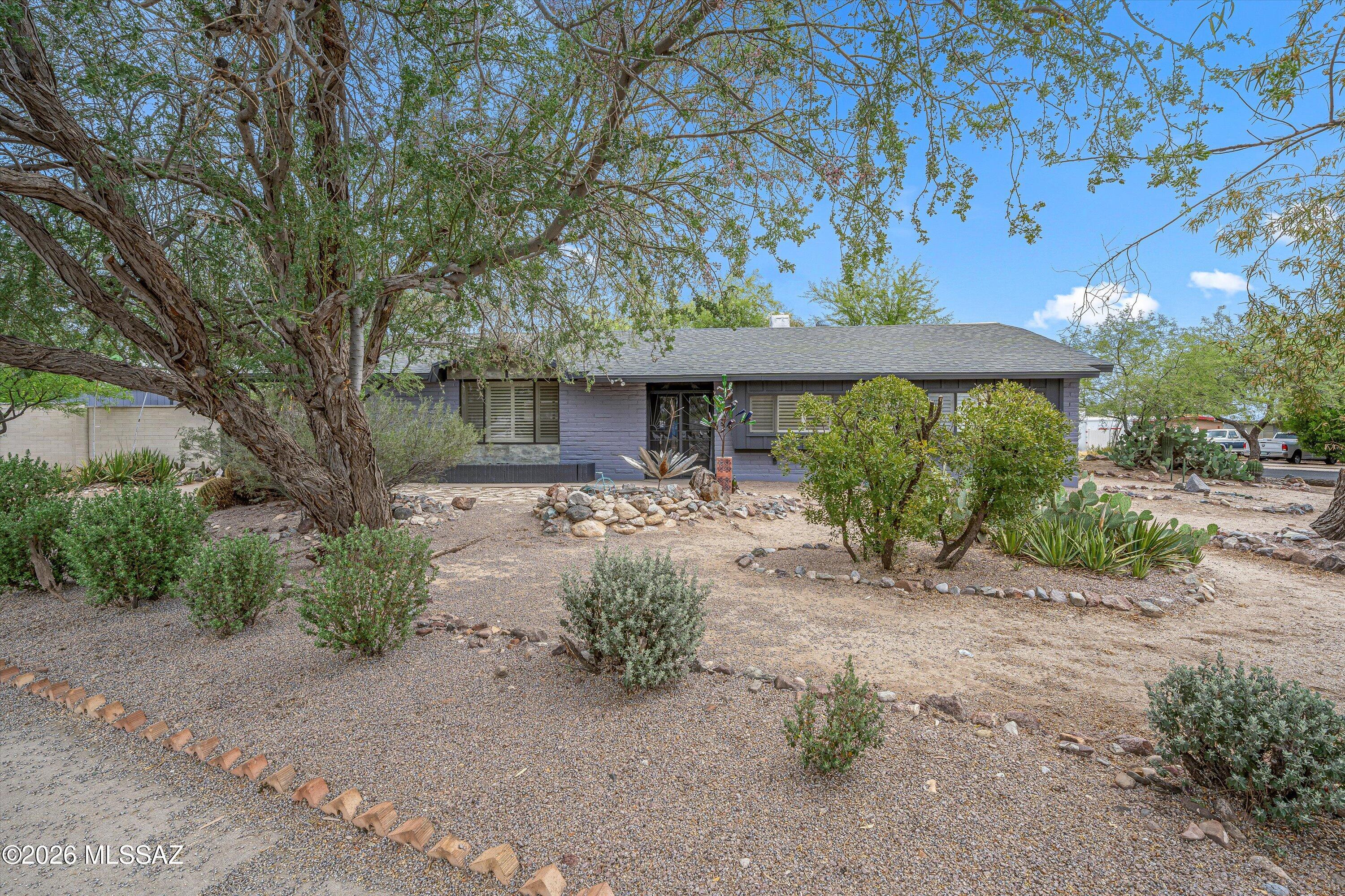 This updated corner lot home blends modern style with the warmth and character of an established neighborhood. Inside, the open-concept living space features wood-look LVP flooring, updated lighting, expansive kitchen storage and a striking electric fireplace. The remodeled kitchen offers concrete countertops, updated appliances, additional cabinetry and generous prep space ideal for entertaining and everyday living. Mature trees and thoughtfully designed outdoor spaces create a private backyard retreat complete with water feature, alley access, Tough Shed storage and screened pet area with dog door. Other pluses are new interior and exterior paint plus roof replacement in 2018. Conveniently located near schools, parks and shopping with a rare combination of charm and functionality.