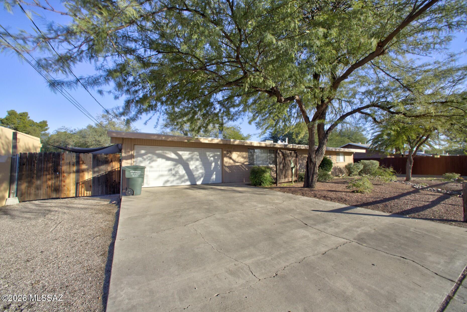 Rare opportunity to own a versatile dual-residence property, perfect for investors, multi-generational living, or a home-based business. The main residence (1,439 SF, built in 1971) features 3 bedrooms, 2 bathrooms, and a 2-car garage. Inside, you'll find tile flooring throughout, a spacious family room with a wood-burning fireplace, a large kitchen with pantry, and comfortable living spaces designed for everyday enjoyment. Outdoors, the home offers a covered patio, mature shade trees, and a fully fenced backyard. The guest house (1,122 SF, built in 2004) provides 2 bedrooms, 1 bathroom, a private entrance, sep parking and fenced yard. Add'l Features include ceramic tile flooring, no Carpet. fresh interior paint, a full kitchen with appliances.   1 YR Home warranty is offered on both homes Additional highlights include recently replaced roofs on both homes, and always maintained by a property managment company.  This unique property presents endless possibilities for rental income, extended family accommodations, guest quarters, or a flexible live-work arrangement.