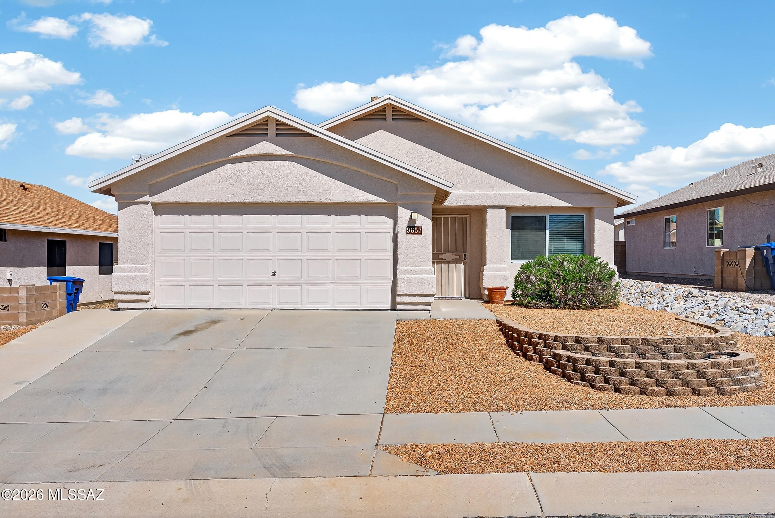 Welcome home! Stunning 3BD/2BA East Tucson gem w/fresh updates: new carpet in family rm & bedrooms, new dishwasher, fresh decorative rock (front/back), & neutral paint thru-out. Two living areas: Living rm w/wood-grain laminate flooring & family rm w/tile-surround fireplace, both w/soaring ceilings & tons of natural light. The kitchen delights w/breakfast bar, pendant lighting, generous cabinetry, warm Corian counters & closet pantry. Dining area flows naturally from kitchen to family room. Inviting owner's suite oasis offers en-suite bath w/double vanity, soaking tub, separate shower & walk-in closet. Inviting backyard boasts covered patio w/extended slab & fresh low-care landscaping-perfect for Arizona outdoor living. 2-car garage, ample driveway & move-in ready--don't miss this beauty!!