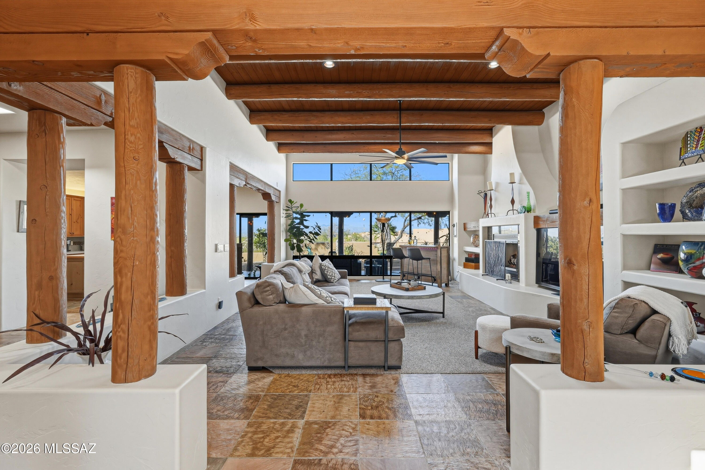 Privately set on over 3 acres in prestigious Tucson Mountain Reserve. This stunning custom home delivers sweeping views of city lights, mountain views and a sense of space rarely found.   Only minutes away from shopping, dining and life's necessities. Massive Vega beams frame an open, light-filled interior with 11 skylights and a dramatic wall of windows in the great room. Slate tile floor and two fireplaces add warmth and character. The Dorado-designed custom kitchen features quartz counters, newer Kitchen-aid appliances and a Boos butcher block island with generous cabinetry.   This home boasts a large primary suite w/fireplace; a second guest suite w/private bath and two additional bedrooms with an option of an office/den. Full length patios front and back create perfect outdoor living.