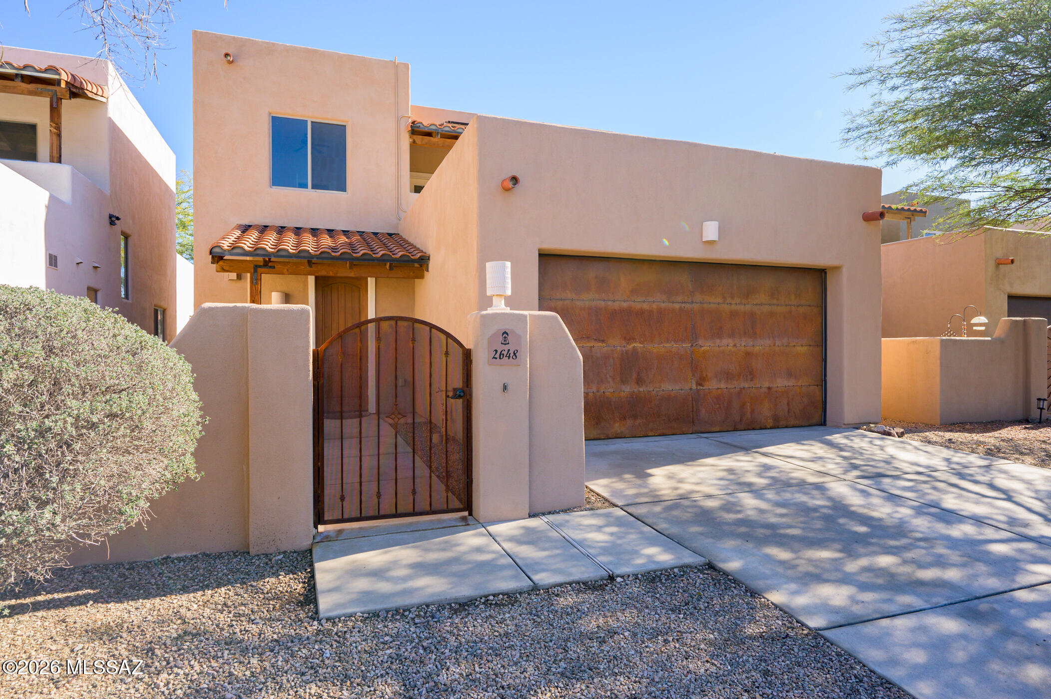 Situated within a fantastic enclave of homes just steps from Ft. Lowell Park, this 3BR/3BA home features scored concrete floors throughout the main areas, large great room with gas fireplace and beamed ceiling, water softener and lower electric bills with owned solar. Abundant kitchen opens up to Great Room for effortless entertaining. Primary Suite features large, walk in closet and bathroom with soaking tub and walk in shower. 2 additional bedrooms upstairs with walk in closets, a sitting area and a bathroom with tub, walk in shower and dual vanities. Sunset viewing from west facing covered balcony upstairs while the sunrise can be enjoyed from the east covered patio and large yard. BRAND NEW HVAC for lower level! Nice entry courtyard and 2 car garage complete this fabulous property.
