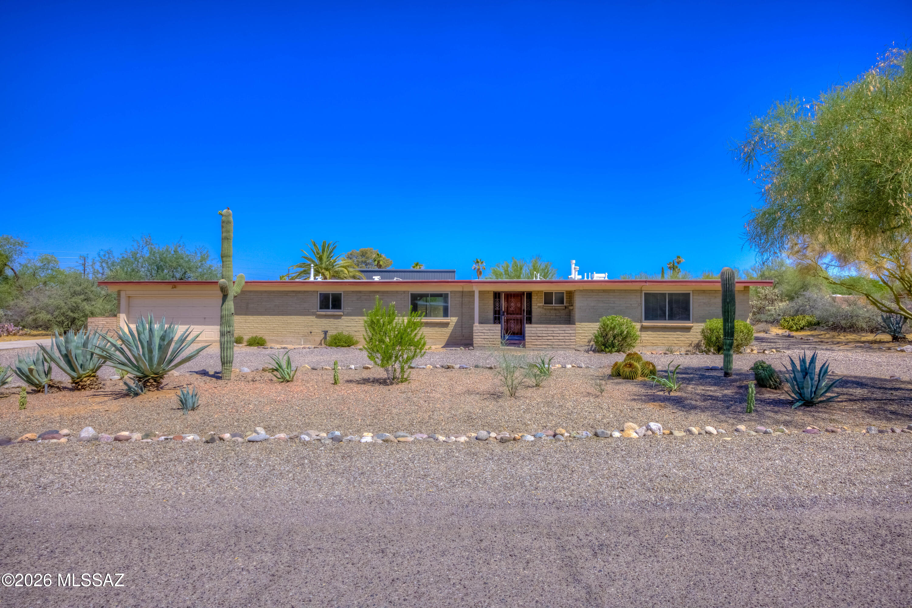 Agent/Owner. Located in the highly desirable Casas Adobes area, this beautifully maintained property offers 3 bedrooms and 2 bathrooms on nearly an acre with no HOA. Inside you'll find a freshly painted interior with ceramic tile and recently installed laminate flooring in bedrooms. Just off the back patio, an additional bonus room with its own mini-split creates the perfect space for a home office, gym, studio, game room, or flex space to fit your lifestyle. Step outside to enjoy the expansive backyard featuring a large covered patio, solar-heated pool, putting green, citrus trees, and mature landscaping. Ample space for RV parking, boats, trailers, or a workshop, the possibilities are endless. Conveniently located just minutes from restaurants, shopping, and award-winning schools.