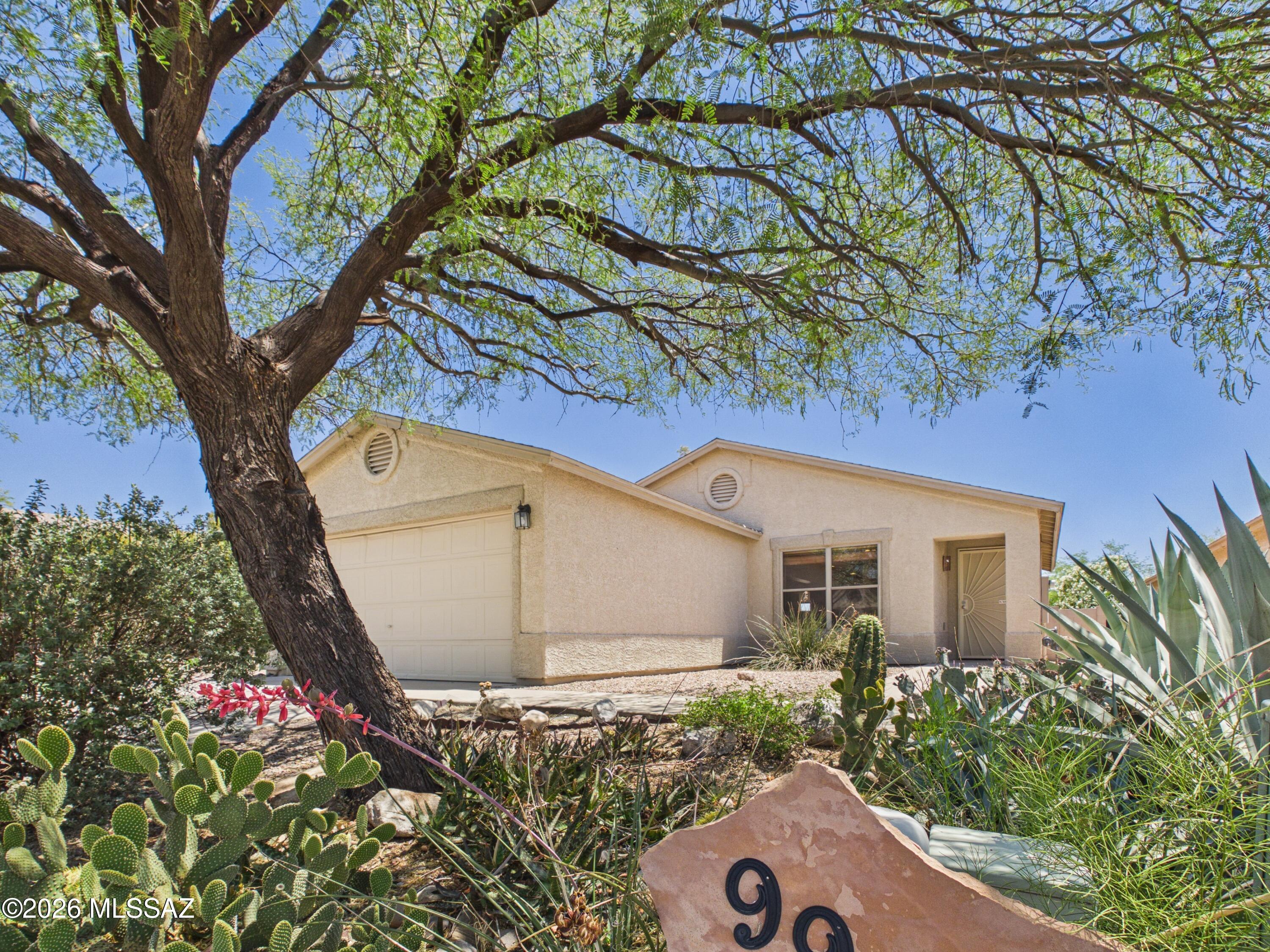 Move-in ready East Tucson home featuring an open great room floor plan with 3 bedrooms and 2 bathrooms. Spacious kitchen offers an island, ample cabinet space, and an eat-in dining area. Tile and vinyl flooring throughout. Primary suite includes private backyard access through sliding glass doors. Enjoy the covered patio, built-in fire pit, and outdoor space perfect for relaxing or entertaining.