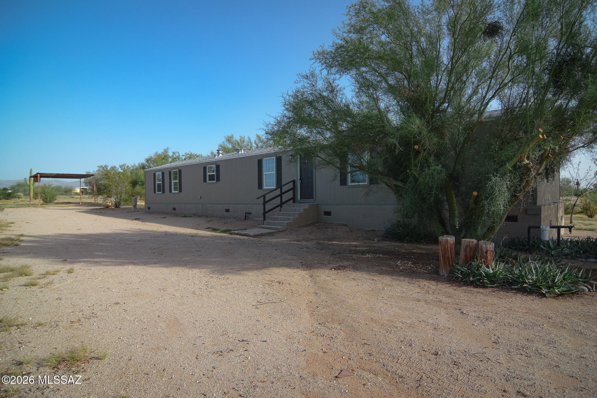 Beautifully remodeled Manufactured home. Located in a scenic Marana location. Rich wood look luxury vinyl plank flooring. Remodeled modern kitchen features SS appliances. New upgraded carpet and padding in bedrooms. New interior and exterior paint. Spacious owner's suite with walk in closet. Large screened back deck. One oversized carport. Newer HVAC. On approximately 2.5 acres of desert landscape. This home shows beautifully.