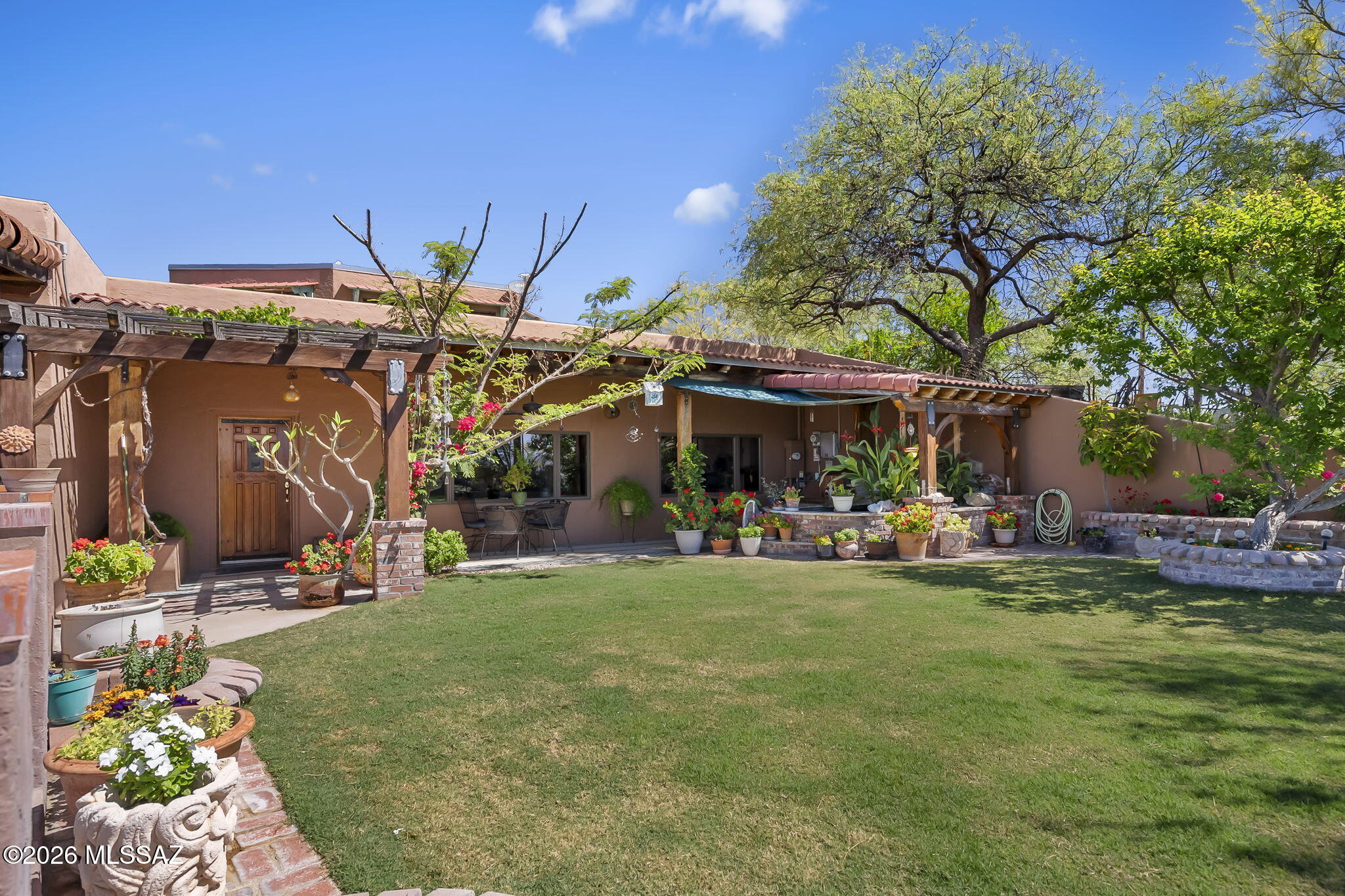 This very unique home blends character and charm with nature-inspired design, featuring rich wood accents throughout that create a warm, inviting atmosphere. Offering 3 bedrooms plus a versatile den and 2.5 bathrooms, the layout is both functional and distinctive. At the heart of the home is a stunning atrium filled with natural light, complete with a spiral staircase that leads up to a rooftop sky deck--perfect for enjoying breathtaking panoramic mountain views. The outdoor spaces are equally impressive, with lush flower beds, vibrant plants, a tranquil koi pond, and even a cozy grass patch, creating a private oasis ideal for relaxation or entertaining. The energy efficient design, insulative building materials and solar make this home easy to heat and cool.