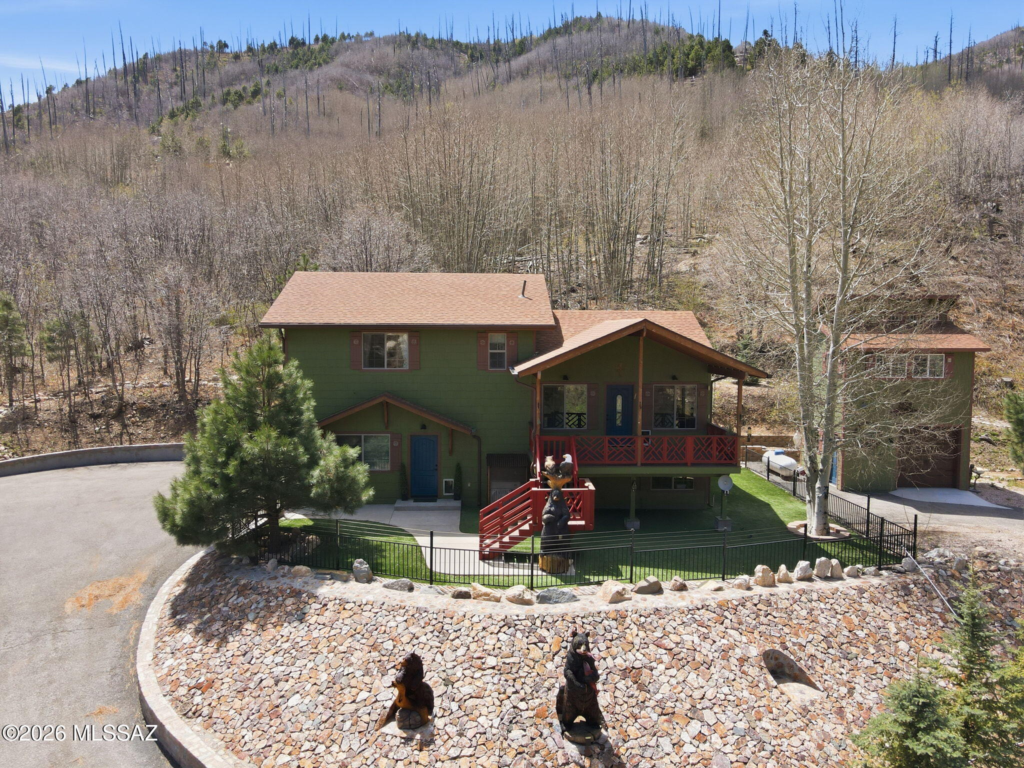 Enjoy the changing seasons in this newly custom built 2020 mountain getaway. Located on a paved road with year round access. This beautifully landscaped 3-bed 2-bath home sits on a double lot of 36,718 sqft with indoor and outdoor spaces perfect for hosting friends and family. Detached 600sqft workshop/garage and a 380sqft bunkhouse with 1/2 bath, sink, microwave and a mini split. 2 paved driveways make for ample parking. Step inside to find a beautifully designed kitchen and living room. Kitchen includes 3 ovens providing maximum versatility for entertaining and cooking, flat top stove, sleek marble counter tops, large farm sink and a beautiful smeg refrigerator. Cozy dining area and breakfast nook with storage under seating to enjoy early mornings with a good book. Living room with a pellet stove to keep you nice and cozy in the winter months and a mini split to keep you cool in the summer.  Upstairs includes 2 bedrooms upstairs with their own mini splits, one has built in shelving perfect for an office space. 2 3/4 baths with lots storage space, and a laundry room with stackable washer and drier. Downstairs includes a large extra room that can be used for endless possibilities. 2 car attached garage with baseboard heating and an extra refrigerator. Beautiful fenced in front yard with turf. Fenced off backyard area with brick floor, gazebo and fire pit to enjoy the beautiful and peaceful mountain air. Custom metal artwork located on the outside of dwellings, unique bear statues that really make the cabin stand out! Generator included! Don't miss out on this one of a kind mountain oasis.