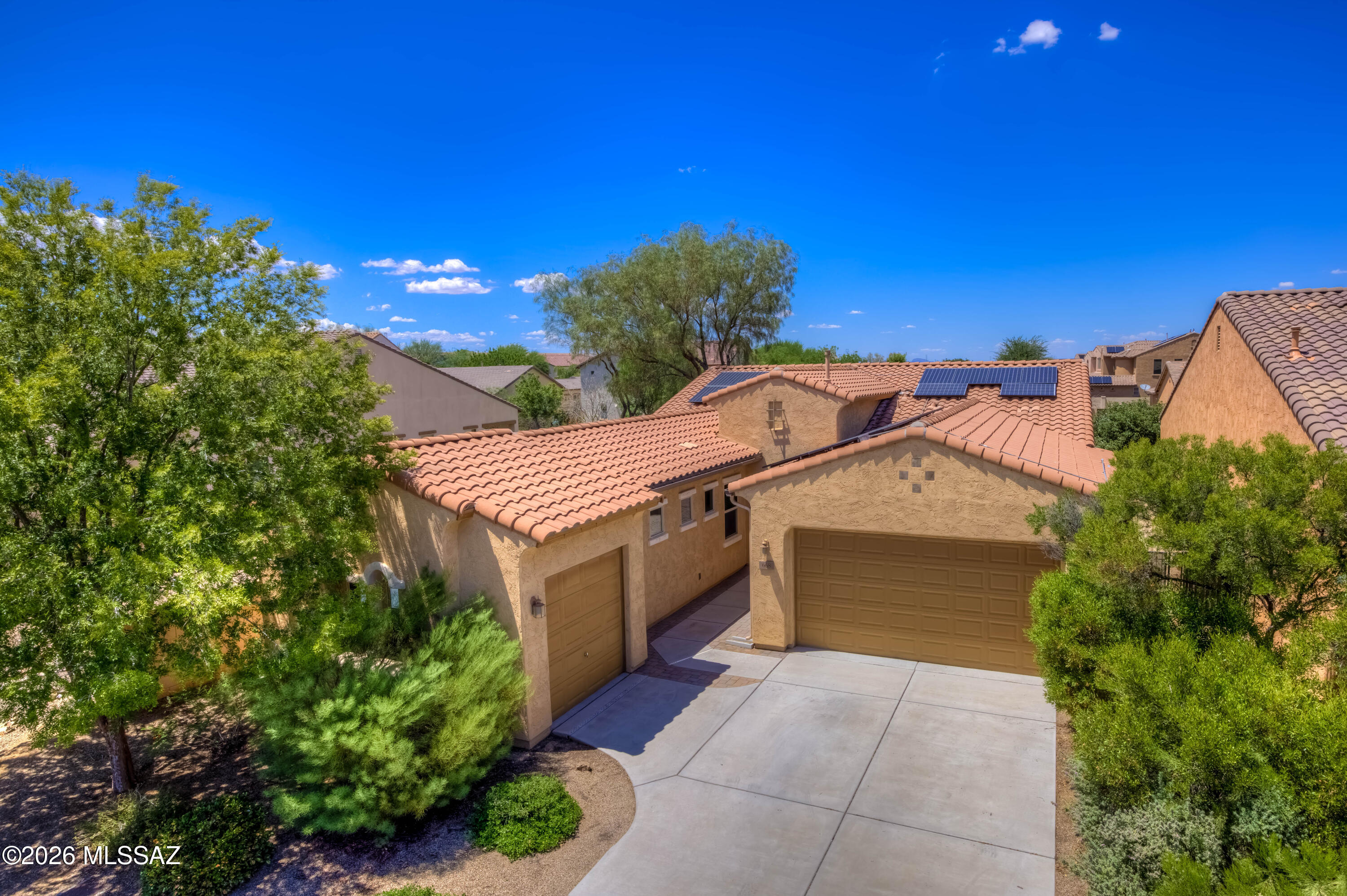 OWNED SOLAR! Inside a private gated subdivision near everything, to include walking distance to the Anza Trail K-8, this spacious home with every imaginable amenity. New paint and flooring. Travertine in all living areas. A formal dining room with a wine cooler and convenient bar space, 4 bedroom split plan, with a convenient hall/guest bathroom with a tub/shower combination. The primary suite offers a luxurious and spacious w/ a large bathroom w/ dual sinks, a walk-in shower, a soaking tub and a HUGE walk in closet directly connected to the laundry room. An open floorplan w/ gourmet kitchen with custom cabinetry, granite counters w/ breakfast bar, gas range w/ stainless steel hood, double ovens, huge walk-in pantry, opening up to a large family room and a large dining space. Read more! Walk outside to the backyard oasis to enjoy the paver covered patio, turf, trees, a garden space, and BBQ, perfect for relaxing or hosting guests. The location is unbeatable, complete with parks, Rancho Sahuarita Club House, Sahuarita Lake, close to shopping, dining and I-19. Extended garages, use your imagination in the separate 3rd car garage! So much more to offer