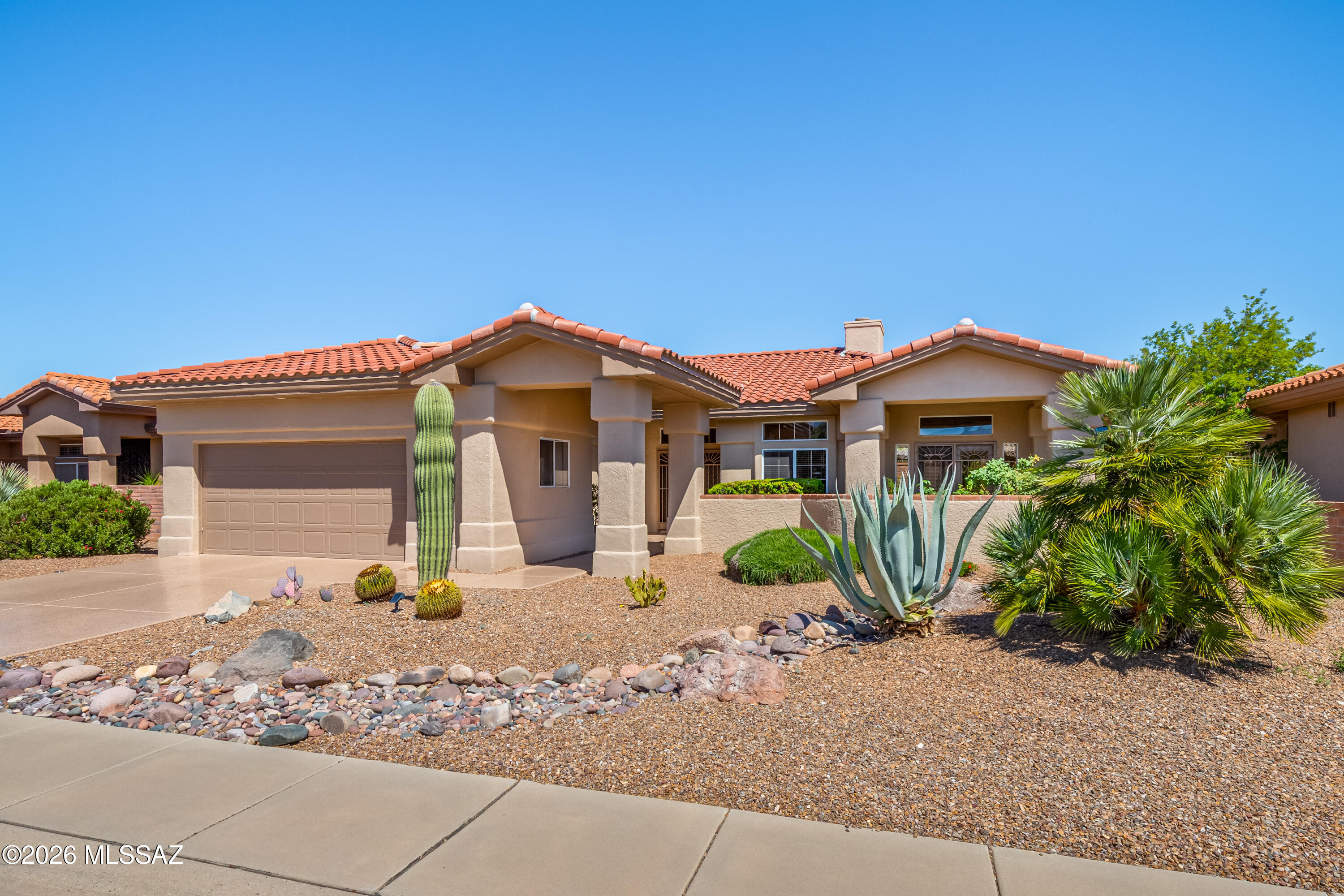 Beautifully maintained, move-in ready Crestview model in the heart of Sun City Oro Valley, an active adult community known for its lifestyle & amenities. This 1,923sf home offers 2BR, 2BA & inviting living/dining room enhanced by walls of windows that fill the interior with natural light. A cozy gas fireplace anchors the family room, creating a warm and welcoming atmosphere. Lovely kitchen has center island, stainless appliances, casual dining area & front patio access. Enjoy mountain views from the front patio, while the private backyard provides a peaceful retreat for outdoor living. Recent updates include fresh exterior paint and newer roof underlayment offering peace of mind for years to come. The epoxy coated driveway adds both durability and curb appeal. Sun City Oro Valley residents enjoy access to golf, swimming, fitness center, tennis, pickleball, walking trails, social clubs, restaurants, and countless recreational amenities. Conveniently located near shopping, dining, medical facilities, hiking, and all the amenities of Oro Valley, including nearby Catalina State Park and the Oro Valley Community Center.