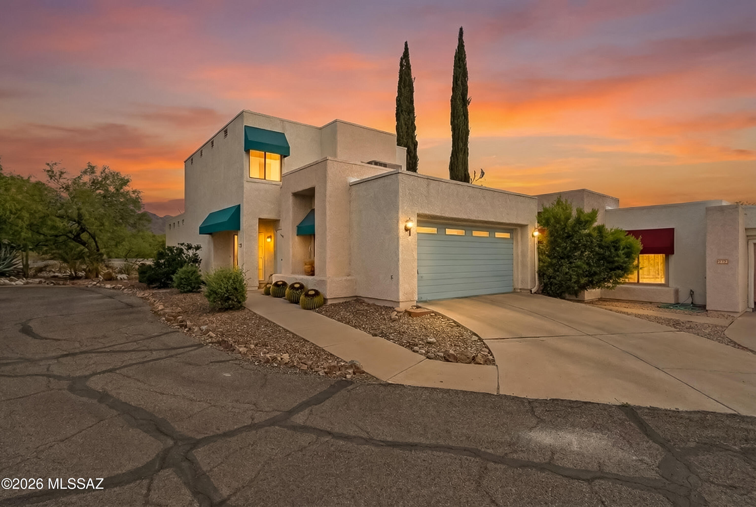Inviting contemporary, two-story located on a cul-de-sac, this well-designed, functional home features a spacious primary suite with ensuite bath on the main floor, soaring ceilings in living room with fireplace, kitchen with granite countertops and stainless steel appliances, large powder bath. Upstairs, two additional bedrooms share a Jack-and-Jill full bath. Backyard with mature trees and mountain views, includes a private screen porch. Owners had polybutylene pipes replaced. Convenient community pool! All within the award-winning Catalina Foothills School District.