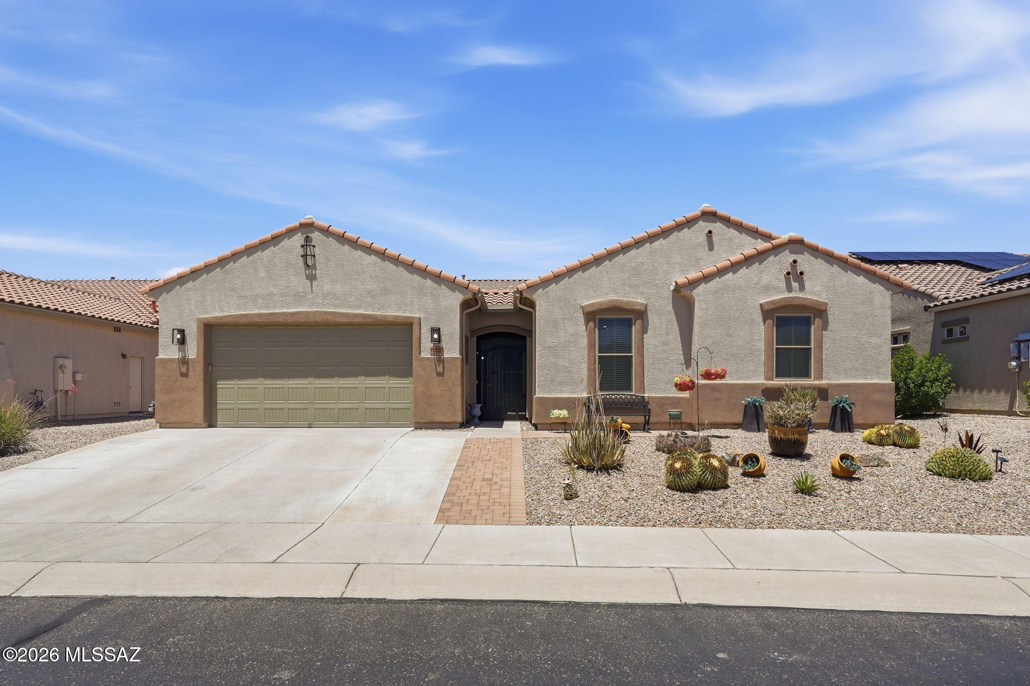 Fabulous 4BD/3BA (2977 sq ft) Maracay Cholla model located in highly desirable gated Tangerine Crossing. Enter through Spectacular custom iron front gate to a serene courtyard. Step into an inviting foyer, large great room, dining room and beautiful appointed chef's kitchen showcasing staggered maple cabinets, granite counter tops, gas cooktop with hood, double ovens, large center island & pantry. Spacious Owner's suite with ensuite bath, double vanities, soaking tub, walk-in shower and closet. Split floor plan allows guest complete privacy with two guest rooms, private bath and bonus room. Separate den/office off great room. Private tranquil backyard with screened in patio. Tangerine Crossing is conveniently located near I-10, amenities, parks, schools, hiking/biking trails and more!