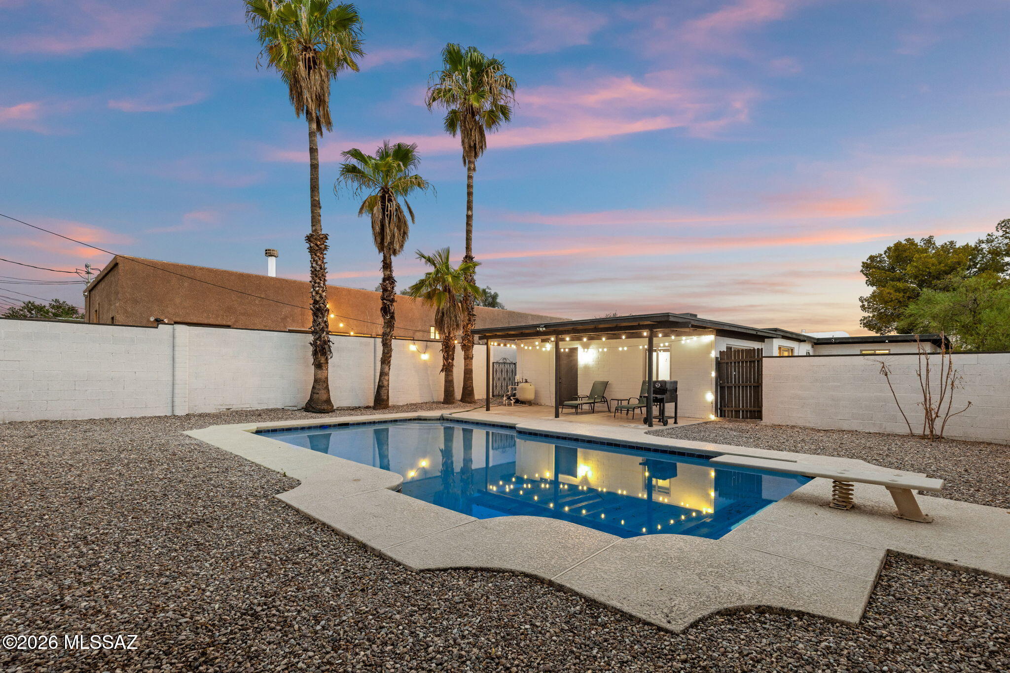Updated 4BR/2BA, 1,685 sq ft home on a corner lot in Central Tucson! Features include a split floor plan, 2 living areas, 2 skylights, quartz countertops, stainless steel appliances and an oversized bedroom with direct pool access. Two separate fenced outdoor areas offer added flexibility, including a private diving pool and covered patio. Great setup for roommates, off-campus housing or an investment property. Minutes from the University of Arizona, Banner-University Medical Center, restaurants, coffee shops, shopping and other everyday amenities. Furnishings included with full-price offer or above. Currently equipped with an alarm system. Furnishings may be included with a full-price offer or above; stacked tables are excluded from included furnishings. Oversized bedroom has direct access to the pool area but does not have a private bath