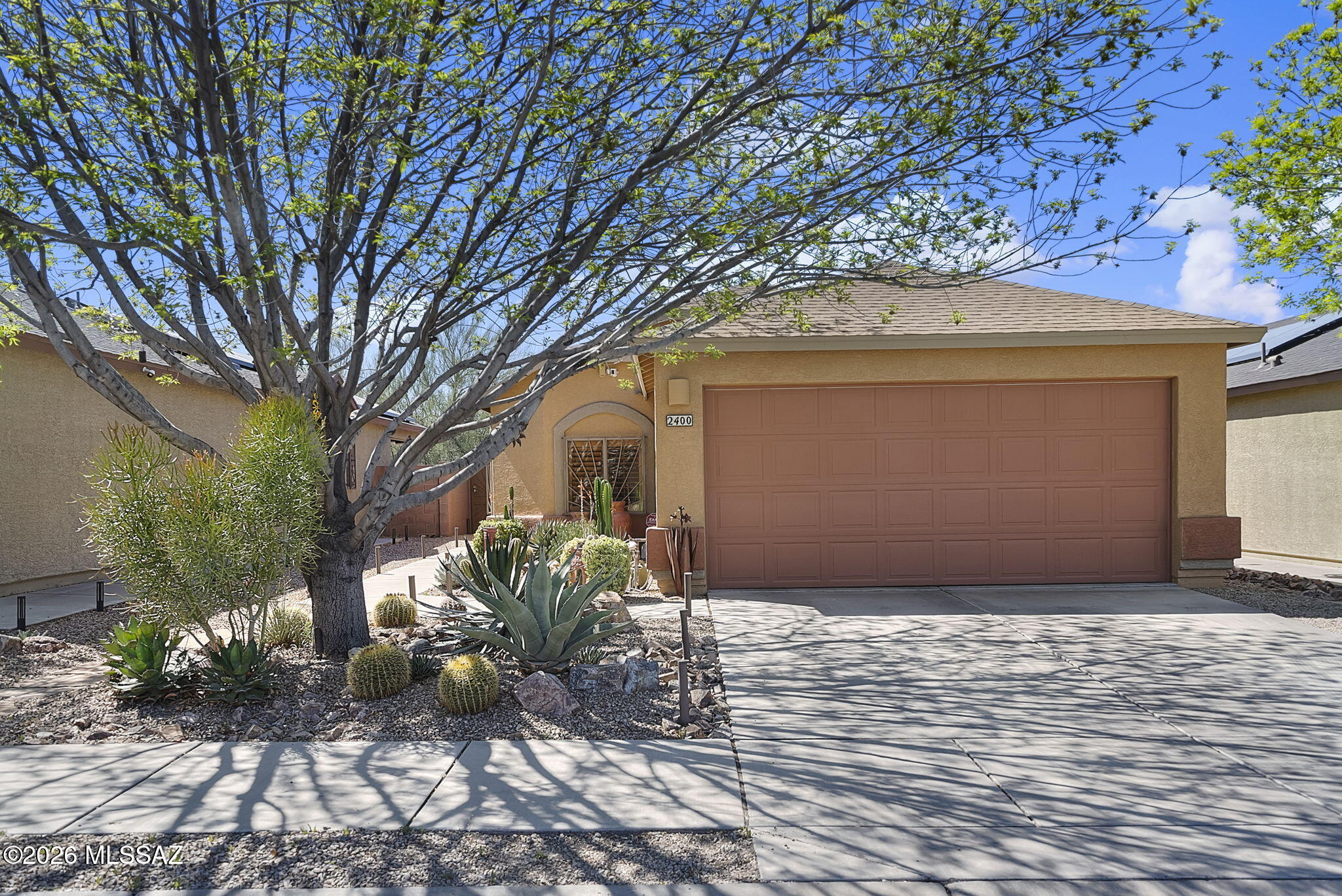 Pride of ownership! This is an immaculate, move-in ready home! Located in a highly desirable neighborhood with mature trees and a community park featuring a playground, picnic area, and bike path.  This home is full of charm, starting with a welcoming landscaped front patio area.  Inside, the open floor plan and soaring vaulted ceilings enhance the spacious feel, while bright neutral tones add to the light and airy ambiance. The custom kitchen features plenty of cabinet space, a tile backsplash, center island, SS appliances, and opens seamlessly to the dining and living areas--perfect for everyday living and entertaining.   The master bedroom includes plant shelves, and a walk-in closet.  Step outside to enjoy the private, low-maintenance backyard complete with a covered patio, pavers, and decorative gravel. Additional highlights include high ceilings, tile flooring, wood shutters, upgraded lighting and plumbing fixtures, ceiling fans in every bedroom, and a French door with integrated mini blinds. Recent updates include a new roof (2021),  HVAC system (2023), wood flooring and molding, decorative wrought iron doors, and a tankless water heater. The home also includes leased solar for added energy efficiency and reduced utility costs.  Centrally located just minutes from Walmart Neighborhood Market, Sunnyside School District, Costco, Tucson International Airport, restaurants, shopping, and convenient freeway access--this home truly has it all!