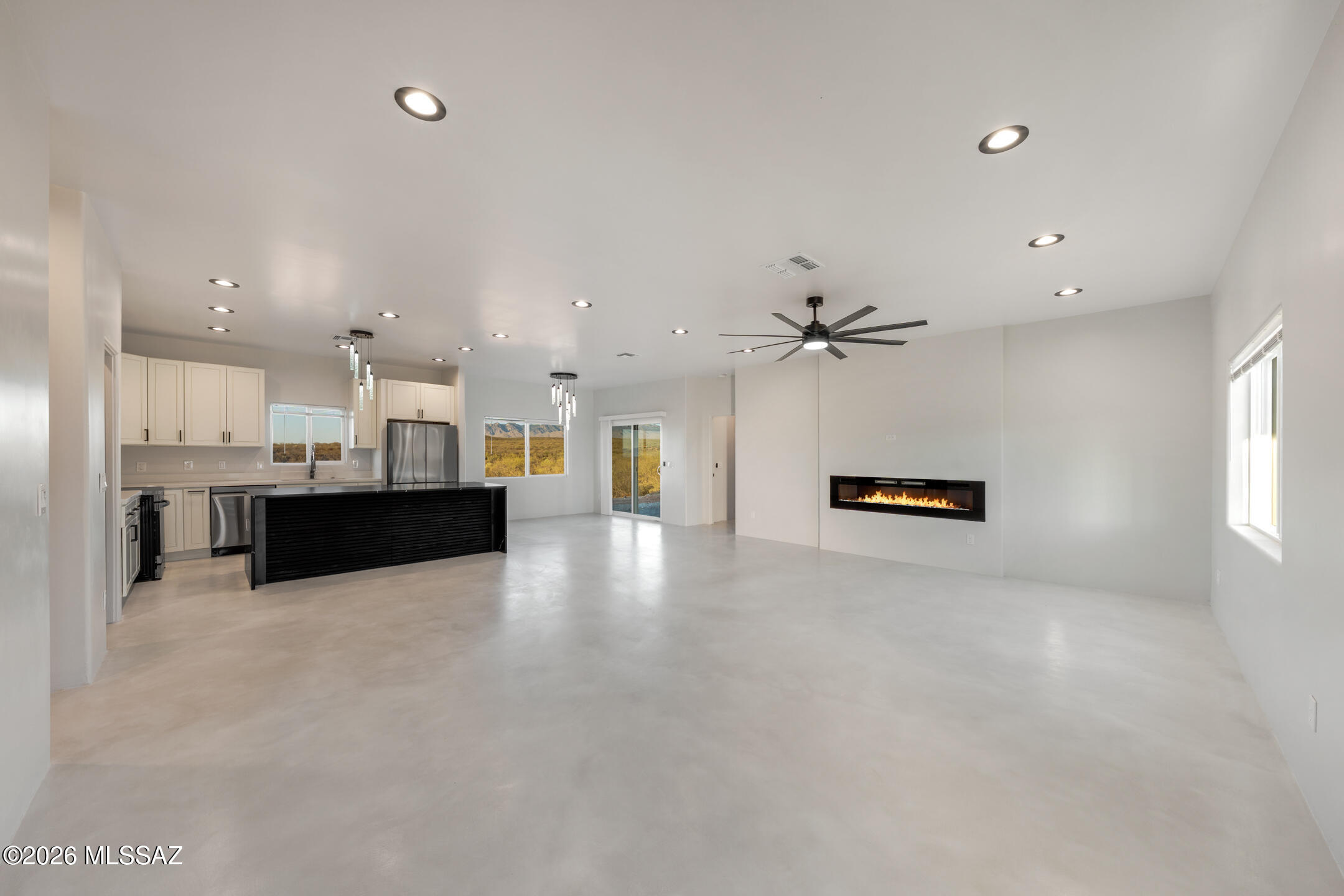 Welcome to 24 Camino Olympia -- a brand-new 4-bedroom, 2-bath home set on over 1.45 acres in Rio Rico Estates, offering panoramic mountain views and thoughtfully designed modern living. Spanning 1,844 sq ft, this residence features a bright open-concept layout with a spacious island kitchen that seamlessly connects to the living and dining areas--perfect for both everyday living and entertaining.

Designed by a licensed architecture firm and built with quality in mind, the home showcases premium materials including synthetic acrylic stucco, closed-cell spray foam insulation, and an energy-efficient HVAC system. Additional highlights include underground electrical service (no overhead lines), undermount cabinet lighting, and a durable slab foundation.

The split-bedroom floor plan provides privacy for the primary suite while offering flexible space for guests, a home office, or multigenerational living. Large windows invite in natural light and frame breathtaking views of the surrounding mountains and valley.

Step outside to enjoy a full-length covered patio and endless possibilities across your expansive lot--ideal for a workshop, garden, or simply taking in the open skies and stunning sunsets. Complete with a 2-car garage, no HOA, and USDA eligibility, this move-in ready home offers the perfect blend of space, style, and freedom.

Your next chapter starts here!