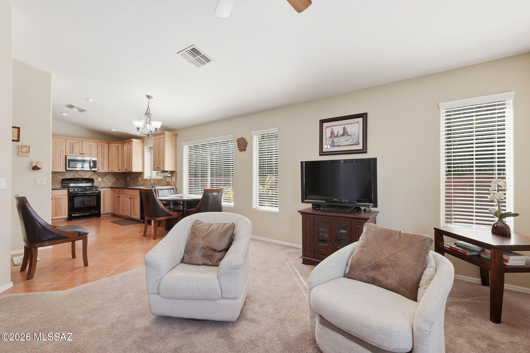 Welcome to this beautifully maintained 3-bedroom, 2-bath with a den home in the sought-after Eagle Crest Ranch community. Built in 2007 and offering 1,858 sq ft, this residence site on a desirable corner lot with attractive curb appeal. The open floor plan features vaulted ceilings, abundant natural light, and a spacious great room centered around a cozy built-in fireplace-perfect for relaxing or entertaining. The kitchen flows seamlessly into the main living area for easy everyday living. Step outside to enjoy the expansive backyard showcasing stunning mountain views, multiple mature trees, and extended paver patio space, creating a peaceful desert retreat. Conveniently located near Oracle Road, shopping, dining, and golf.