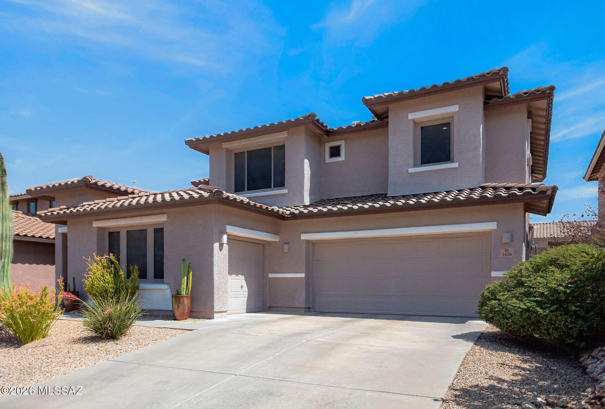 Step inside to a bright, open floor plan styled with rich wood flooring and tile planks. Large tinted windows throughout keep the home bright while enhancing energy efficiency and indoor climate control during warmer desert months. Spanning roughly 2,500 square feet, the layout offers 3 spacious bedrooms plus a flexible den, ideal for a dedicated home office or media room, eat in kitchen, dining room and four bathrooms. Master and guest bedroom both have on-suite bathrooms to give the home dual Master suites. The loft area can be used as another office, library or sitting area.  Gourmet Kitchen: The kitchen seamlessly opens to the family room and  features  granite countertops and bar seating for 5, an undermount sink,  stainless steel appliances to include: Gas range, built in microwave, dishwasher and a side by side refrigerator with water/ice dispenser. You will love the butlers pantry with extra cabinetry and granite countertop.
Designed for outdoor entertaining, the backyard is built around the Southern Arizona lifestyle. A beautiful covered ramada with tile roof provides shade, anchored by a built-in BBQ grill and plumbed for a mister system to keep outdoor gatherings cool year-round. The resort like yard has an extended brick paver patio, beautiful landscaping and brick paver walking paths.
A New Garage Door Motor Chain/Belt and springs. Full 3-car attached garage provides ample space for vehicles, desert recreation equipment, and an integrated workspace with a workshop and storage. Situated in Marana's desirable Tangerine Crossing neighborhood, residents enjoy gated security, low quarterly HOA fees, community park access, and proximity to top-rated Marana Unified schools to include Dove Mountain Elementary and Middle Schools.
Close to Golf, hiking, biking, shopping and restaurants.