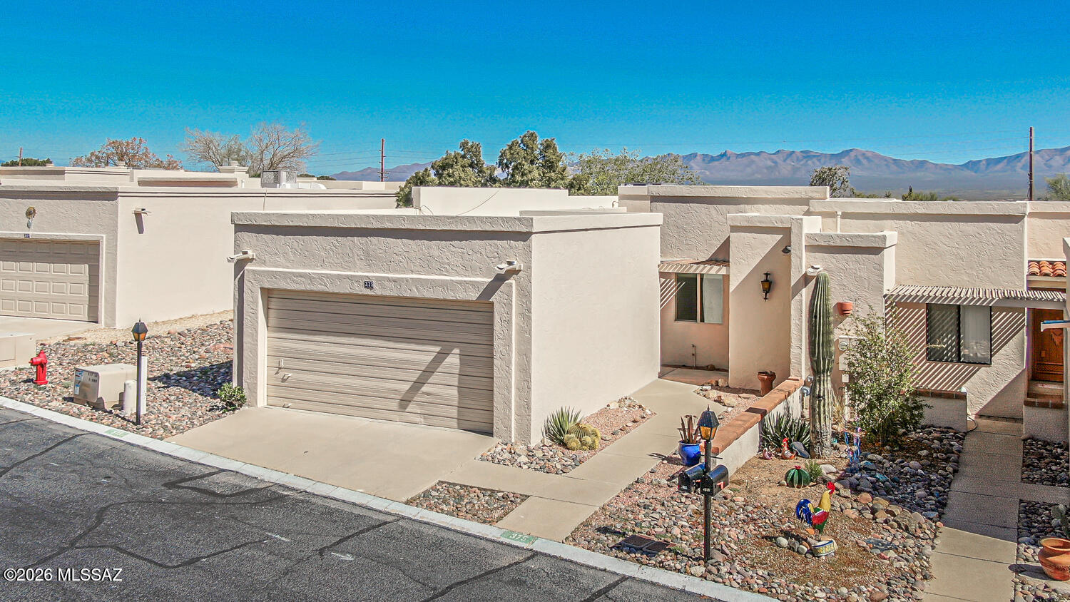 Embrace the Green Valley lifestyle in this fantastic 2-bedroom, 2-bath end-unit townhome with a desirable 2-car garage, designed for comfort and easy living. Major System Upgrades Already Done! Brand-new HVAC system, brand-new water heater, newer windows, and a freshly recoated roof--giving you comfort, efficiency, and peace of mind for years to come. Beautiful tile flooring runs throughout the main living areas, with newer carpeting in the bedrooms adding warmth and comfort. The light-filled living room welcomes you with an open, airy feel and flows effortlessly into the dining space featuring a wet bar--perfect for entertaining. The tastefully updated kitchen is both stylish and functional, showcasing sleek granite countertops, rich Knotty Alder wood cabinetry, and a charming breakfast nook. The spacious owner's suite offers a relaxing retreat with a large walk-in closet and a private bathroom featuring dual sinks and a walk-in shower. A comfortable guest bedroom and full bathroom provide a welcoming space for visitors. Additional highlights include abundant storage throughout the home, a recently serviced electrical panel with new GFCI outlets installed in wet areas for added safety, upgraded window treatments, and a low-maintenance backyard with a covered porch, the perfect place to relax, unwind, and enjoy the beautiful Arizona weather year-round. Enjoy a prime location near the GVR pool and close to shopping, restaurants, and the local farmers' market. Green Valley Recreation membership provides access to pools, fitness centers, classes, shows, and a wide variety of amenities. Perfect as a winter getaway or comfortable year-round home in this 55+ community. A truly wonderful property you won't want to miss!