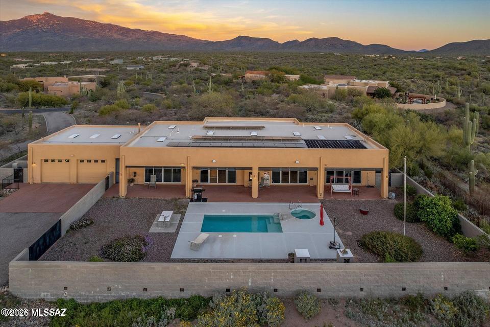 Property Description
This contemporary home sits on 2 acres and offers jaw-dropping views of the Rincon Mountains and ranges beyond. Custom built in 2005, the open-concept design features a massive 30' x 40' great room with 54' of glass, a striking see-through fireplace, and a flowing split-bedroom floor plan ideal for effortless living and entertaining. Two Full length, 10' wide brick verandas extend the living space outdoors, offering breathtaking 360-degree views of the Tucson valley and surrounding mountains. Nestled in the Sonoran Desert, Coyote Creek features walking paths throughout and community amenities nearby - making this home the perfect blend of modern design, comfort, and Arizona beauty.