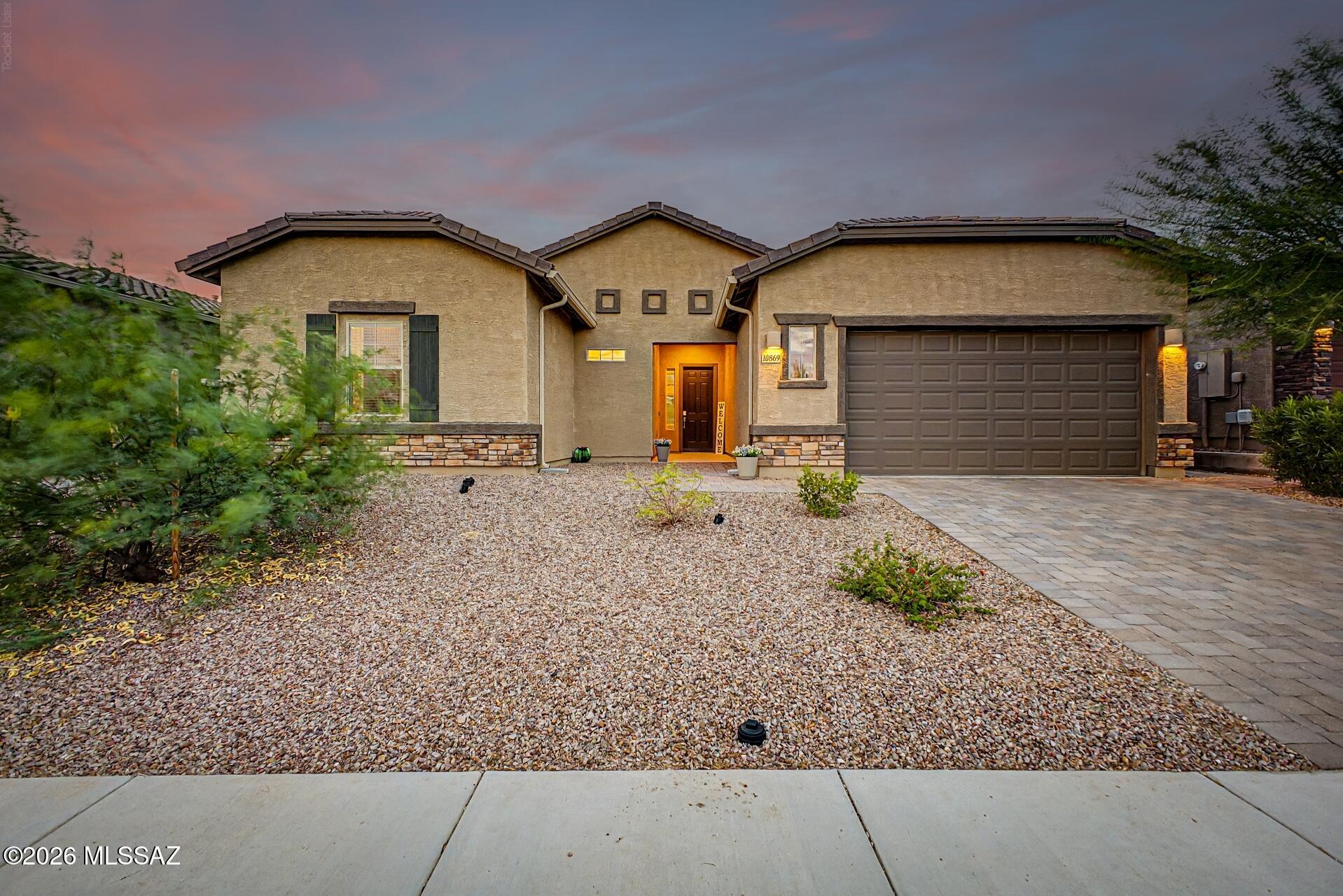 Exceptional indoor-outdoor living awaits in this beautifully upgraded 4-bedroom, 2-bath home. The open great room flows through a 12' sliding glass door to a professionally landscaped backyard featuring a travertine patio, custom gas fire pit, artificial turf, and covered entertaining space. The kitchen showcases granite countertops, upgraded cabinetry, designer backsplash, and a large island. Retreat to the spacious primary suite with two walk-in closets and an elegant walk-in shower. Every detail has been carefully selected to create a home that's as functional as it is beautiful.