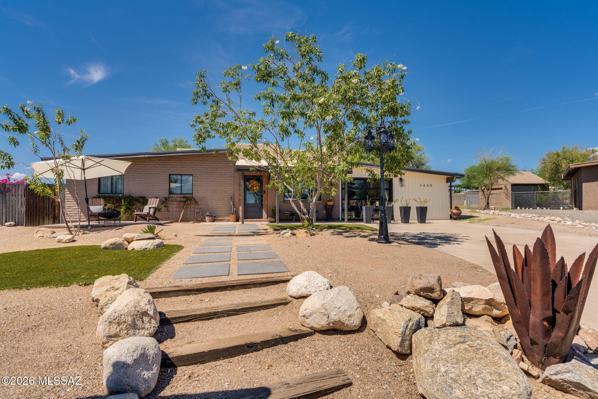 Mountain views, sunset skies and outdoor living set this ranch-style home apart! Situated on a large lot at the end of cul-de-sac. This 3 bed/2 bath home offers character, flexible living spaces and a beautifully landscaped setting. Saltillo tile flows through the main living areas with hardwood flooring in bedroom(s). Updated kitchen features quartz countertops, stainless steel appliances and updated cabinetry, while a dedicated office offers built-in cabinetry. Primary suite features a closet w/built-ins and French doors opening to a private covered patio. A mudroom provides access to a separate bedroom, offering added privacy and flexibility. Multiple entertaining areas including an expansive backyard, covered and uncovered patios, built-in seating and an unfinished detached studio