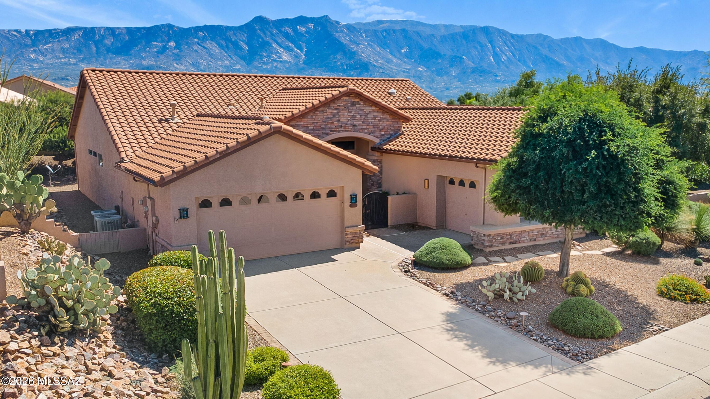 Updated Dakota with Owned Solar & Mountain Views! Great curb appeal with gated courtyard & stacked stone accents. Great Room features media wall with adjacent dining area. Kitchen offers quartz counters, stainless appliances, gas cooktop, Island, custom cabinetry & solar tube. Family Room has slider to patio. Owner's Suite with bay window & patio door. EnSuite bath has quartz counters, custom walk-in shower, stand-alone soaking tub & walk-in closet. Guest Bedroom #1 with closet & Guest Bedroom #2 has walk-in closet plus solar tube with guest bath nearby. Laundry Room with W/D & cabinets. Extended 2-car garage with utility sink & cabinets, plus separate 1-car garage. Covered paver patio extends to paver patio, AstroTurf & water feature. Lovely landscaping, gated yard & mountain views!
