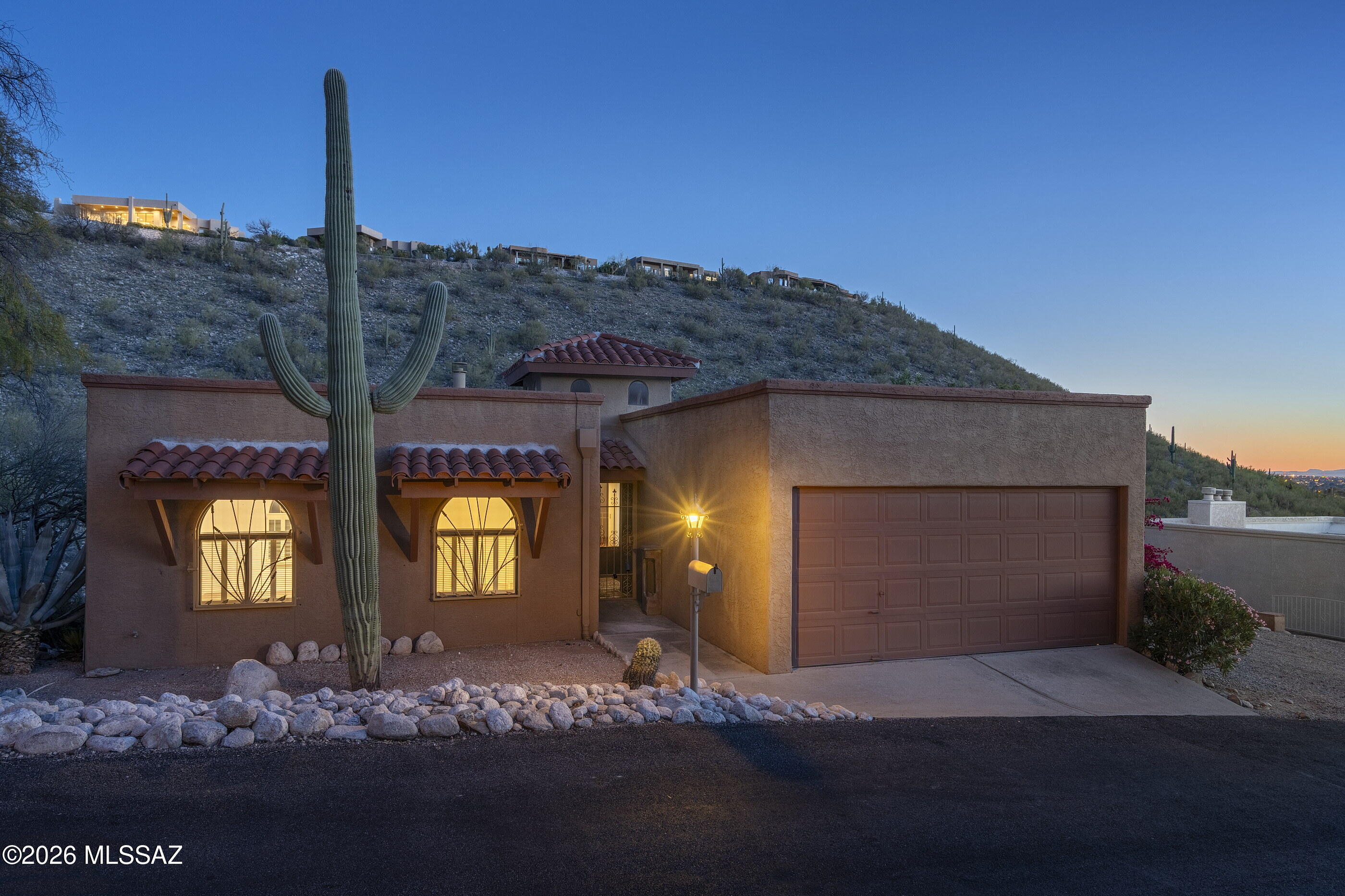 Seller shall entertain offers between $600,000 - $635,000. Looking for income potential? A home  & an Office? The scenic foothills of Sabino Canyon is the setting for this gorgeous 2 level offering sweeping views of untouched hillside saguaro desert & sparkling city lights! Two separate living areas w/a 3 bdrm/2 bath upstairs, and downstairs (1500 sq feet) 2 bdrm/1bath w/den & new kitchen. Both sections have their own entrances & NEWER ZONED HVAC. Homeowner added over $100,000 upgrades since they have owned the home. See list of upgrades attached to this listing.  NEWLY remodeled primary bathroom on main level offers a large walk in shower & will accommodate a wheelchair. Newly remodeled kitchen w/custom butcher block island. Check out the catico on west side of home off living area.