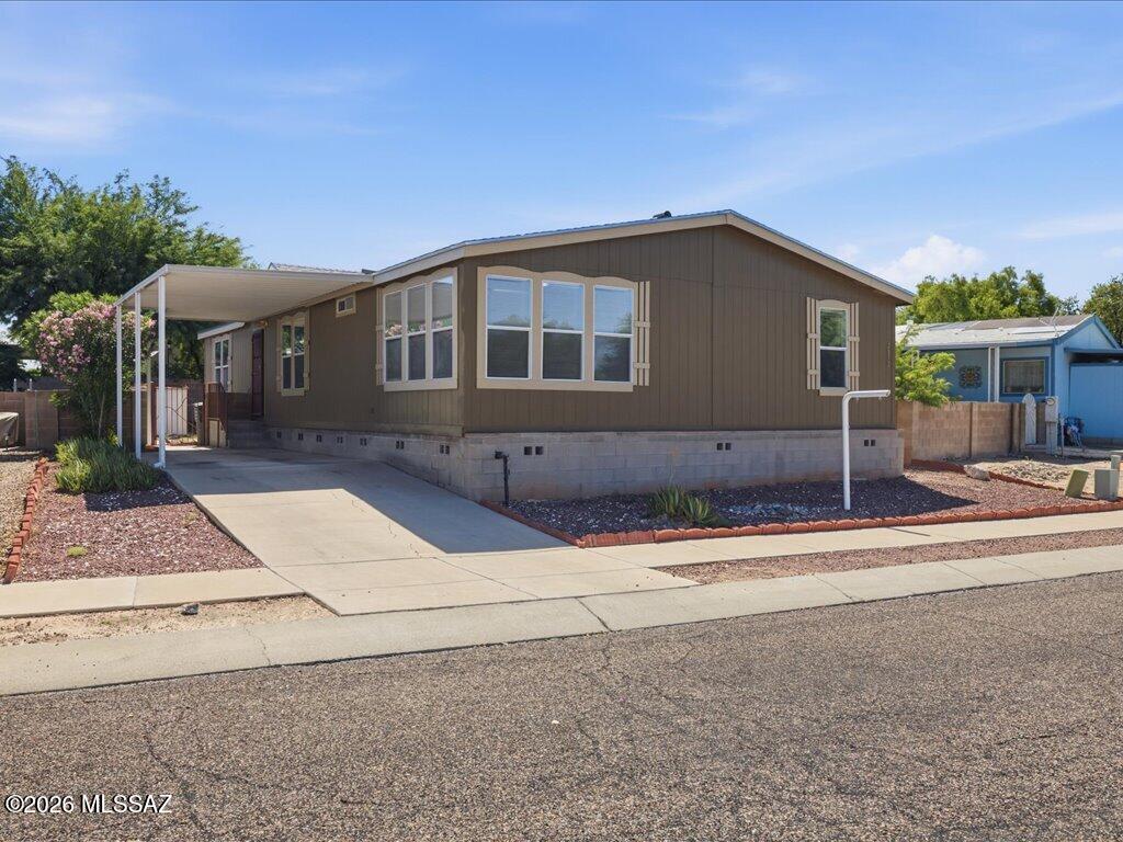 Assumable 4%  FHA loan !!! Welcome home to this beautifully maintained 2003 manufactured home in Country Club Terrace! Recent upgrades include a newer HVAC system, water heater, and roof, offering peace of mind for years to come. Inside, enjoy a generous living area, separate dining space, and a well-appointed kitchen, plus a spacious laundry room for added convenience. A versatile den/study makes the perfect hangout spot, sitting just off two additional bedrooms and the hall bath. Step outside to a private, block-walled backyard and covered back patio for our lovely Tucson evenings. The community is blessed with mature trees and vegetation.   Lovingly cared for by its current owner, this home radiates pride of ownership throughout. Don't miss this gem!