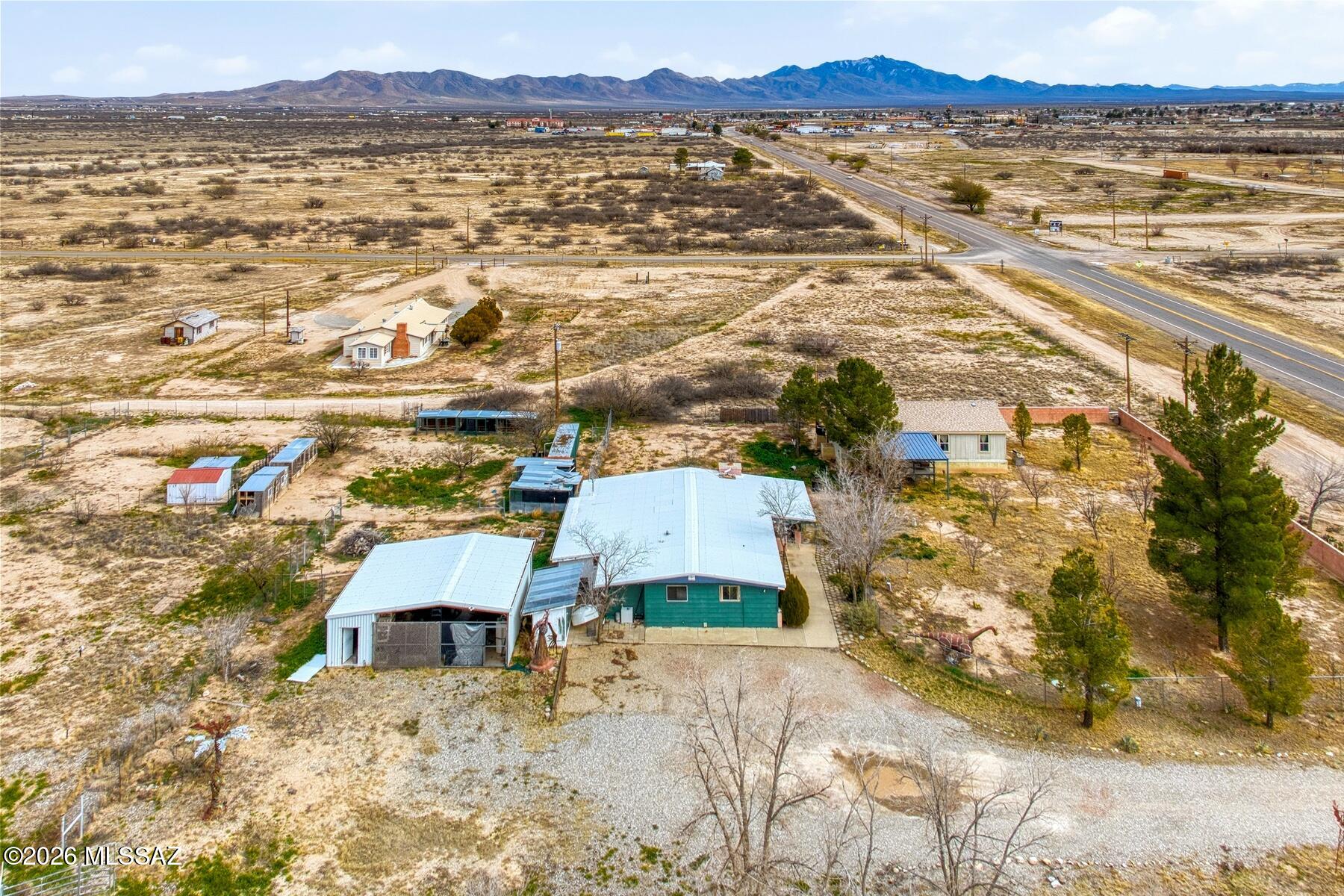 Unique live/work opportunity on 3 acres in Willcox, AZ (additional Photos to come). Property includes a 2013 Manufactured Home 1104 sf with 3 bedrooms, 2 bathrooms & the original home - 1,907 sq ft, built in 1981 that has been converted for use as a veterinary clinic and is not currently configured as a residence.( was 4 bedrooms, 2 bathrooms with Kitchen, Laundry, enclosed porch, indoor kennels and storage rooms, site built, metal roof, fireplace) The property features cross-fencing, perimeter fencing, a large metal two-car carport with concrete slab, multiple storage areas, and multiple kennels. Two wells serve the property - 1 servicing the home and converted structure & 1 can be used for outdoor watering. Multiple Fruit Trees. Zoned RU-2 allowing residential and commercial uses. Original Home was converted into a Vet Clinic has metal roof.  Can be restored by adding in closets, installing kitchen and renovation of hall Bathroom. Only 1 of the 2 wells is registered -  55-220369 3/4/2011 - Depth 95'/ Static 60' / Hole Diameter 8". Appointments must be made to view the Home with the Listing agent present for all access to property.  NO keys will be given out, Security cameras all over. Manufactured Home will be affixed through contract and before Close of Escrow to meet lending requirements.