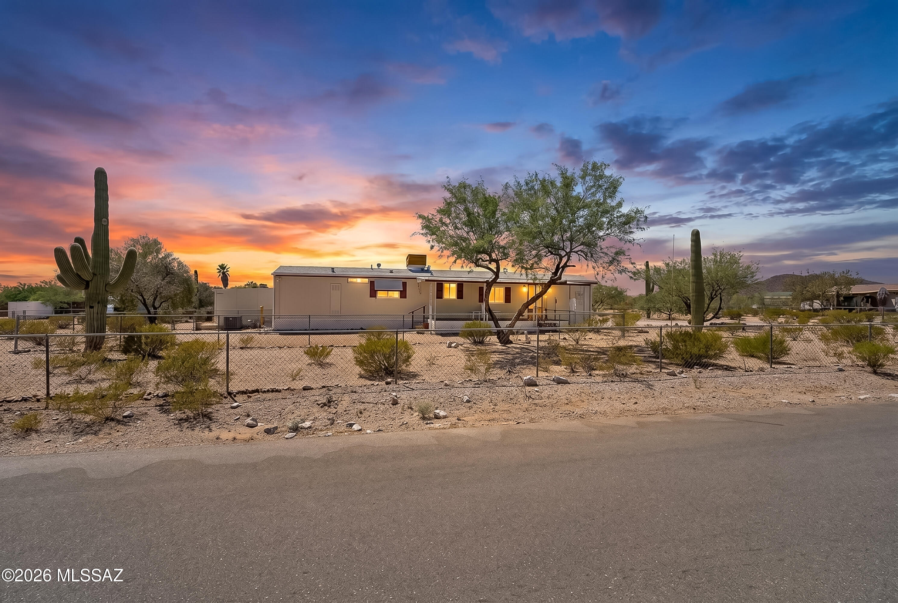 Awesome, and Affordable. Back on the market today 6-12! RARE Desert Haven! 0.46-ACRE! Corner Lot. SAGUAROS & Mesquites! Enjoy CAT MOUNTAIN, as well as Distant Mtn VIEWS on all sides. FULLY FENCED PERIMETER, plus Addtl. Interior Yard for Pets & Play! AFFORDABLE & Move-In Ready! Located in Tierra Bonita subdivision: PAVED STREETS, City Water, Sewer & NO HOA. 1984 Palm Harbor 14-wide! Great Room, 2 FULL BATHS. Split BR Design! ONE OWNER HOME that's Comfortable as-is, yet awaits your personal touch. 2 COVERED DECKS East & West! Central AC & Vinyl-Clad Dual-Pane Windows for superior efficiency! 2010 Re-Pipe (no poly)! Quality, Aluminum Carport W/ Side Awning to Shade Home & Long Enough for a Truck. 2015 ROOF! 2021 Water Heater. Sturdy Tuff-style Shed included!
