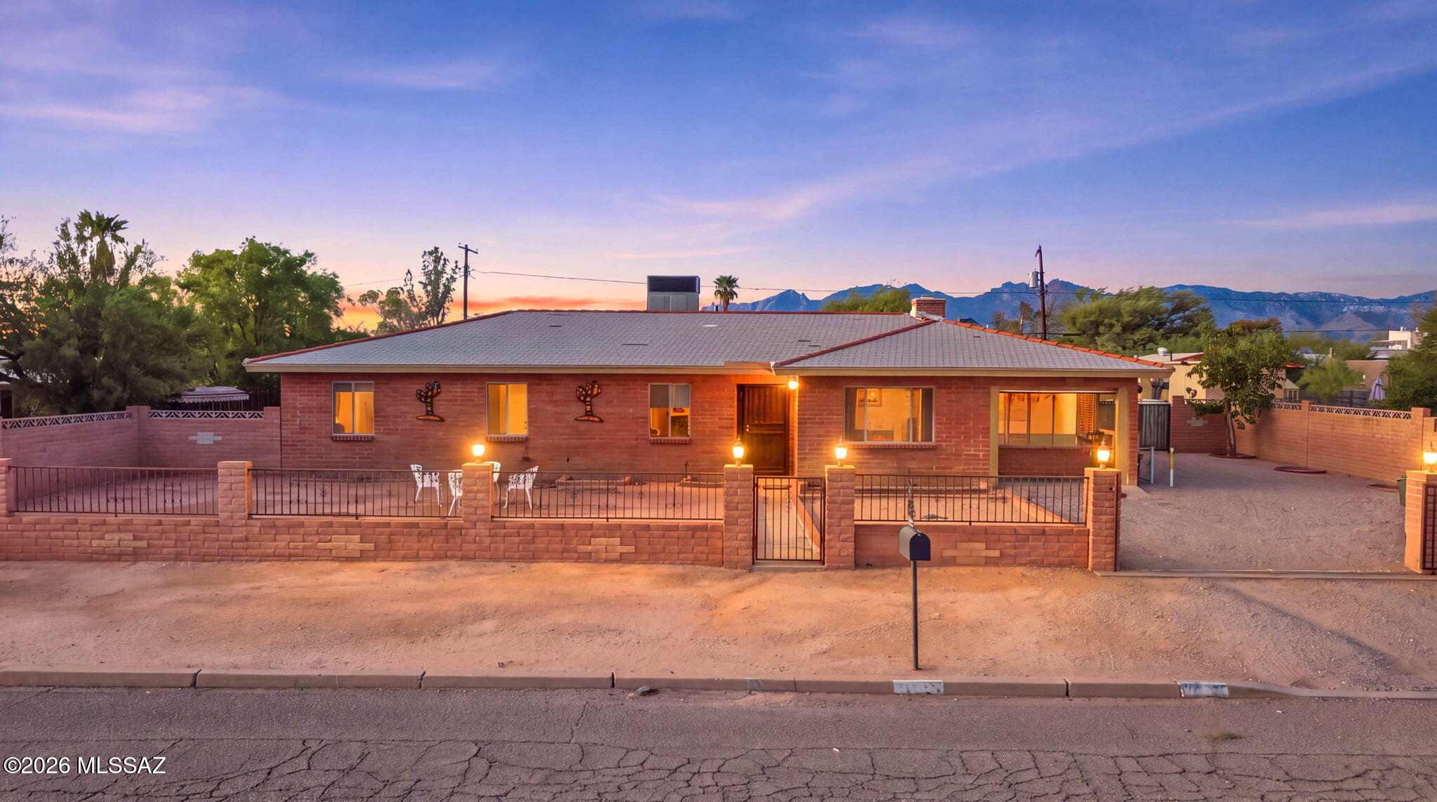 Spacious Burnt Adobe home built in 1973 on an oversized lot in the desirable Palomar Neighborhood!  This home offers a comfortable indoor and outdoor living space with 3 bedrooms, 2 bathrooms, updated ceramic tile flooring, dual-pane windows, recessed lighting and a beautiful wood burning fireplace in the living room.  Tankless water heater and whole house water filtration installed in 2023. 
Outside enjoy the masonry ramada and large additional garage/workshop or studio with potential for a Casita.  This home is perfect for gatherings and/or your projects.   A small storage room is attached behind the ramada for all your yard tools/supplies. Situated on an oversized lot (over a quarter acre) and just one block away from Reid Park/Randolph Golf Course/Rec Center, shopping and dining.