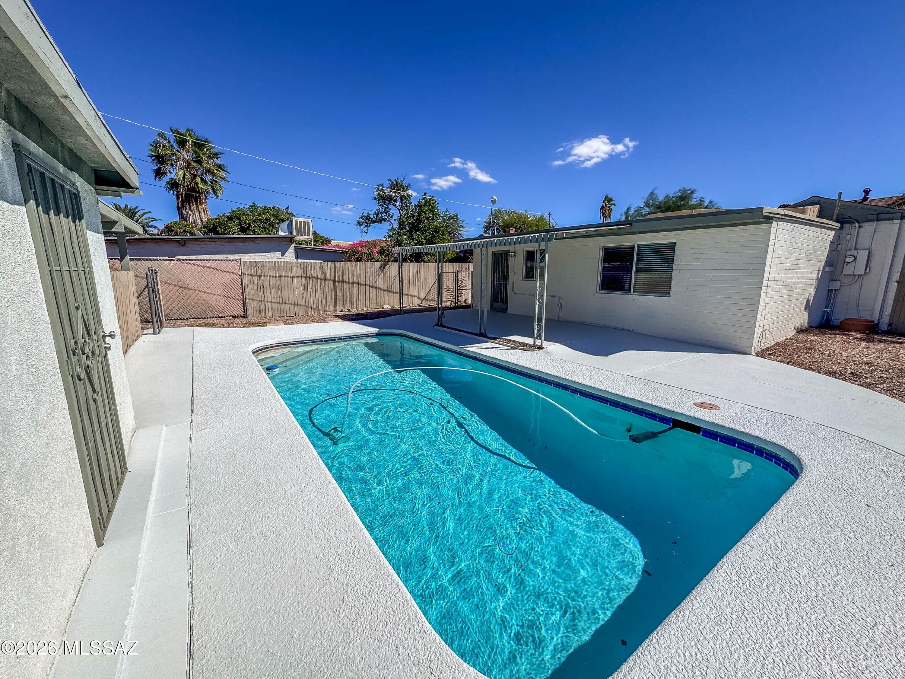Beautifully Renovated Home with Private Pool & Detached Bonus Room Near UA and Banner
Extensively renovated corner-lot home with a private pool and detached fourth bedroom near the University of Arizona and Banner-University Medical Center.

The three-bedroom, two-bath main house features a split-bedroom layout and thoughtfully updated interiors. The remodeled kitchen includes quartz countertops, custom cabinetry, a farmhouse sink, new gas range and dishwasher, and gold-tone fixtures. Tile flooring throughout, updated lighting, new dual-pane windows, fresh interior and exterior paint, and new door hardware complete the refreshed look. A new stackable washer and dryer adds everyday convenience.

The primary bathroom features a custom shower tub combination and dual-sink vanity. The sec athroom offers a walk-in shower with sliding glass doors and updated finishes.

The detached fourth bedroom includes its own closet, heating and air conditioning, and additional storage, providing flexible space for a home office, studio or guest room. Both bathrooms are located inside the main house; the detached room has no bathroom.

Enjoy a private swimming pool, covered parking for two vehicles, and a convenient central Tucson location with easy access to campus, Banner, Campbell Avenue dining and shopping, and downtown Tucson. Updated finishes and versatile space make this home a distinctive rental opportunity.