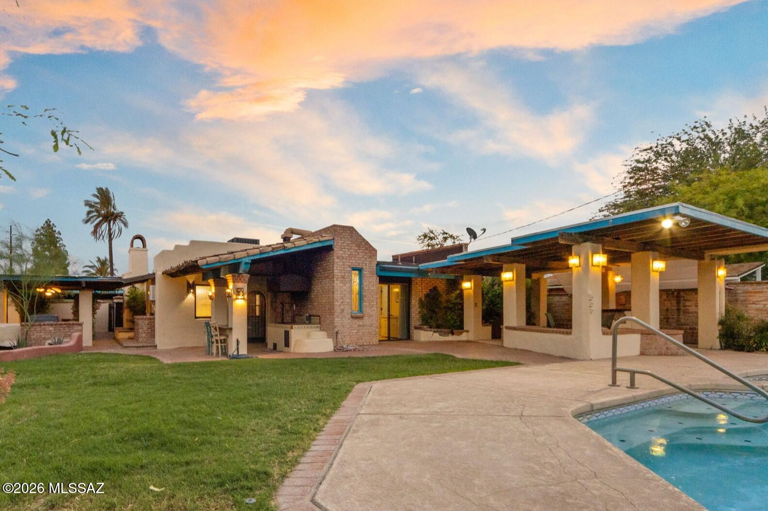 Tucson charm exudes from this home! From the moment you walk through the charming courtyard, inside to the remodeled yet comfortable spaces, and a magical backyard...you will say WOW!  Inside; 3 bedrooms & 3 bathrooms, a space for everyone! Exposed brick wall with fireplace, & Bright updated kitchen packs in all basic needs. Split bedroom floorplan with great sized rooms and access to backyard from 2/3 rooms. New AC (2024) Dual pane windows + Doors (2022) Tankless water heater (2022). Outside; Multiple covered patios, Pool/spa, Koi pond, Built in BBQ, sink and space to entertain. There is so much about this home that sets it apart from the rest! Nestled in Jefferson Park, this home is close to it all including UofA, Banner, Fine dining and so much more!